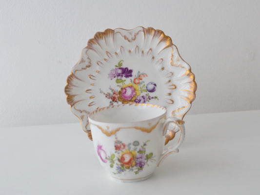 Dresden porcelain cup and saucer, R. Grossbaum & Söhne circa 1892–1914, hand-painted floral bouquet, shell-relief moulding, gilded rococo edge, front view