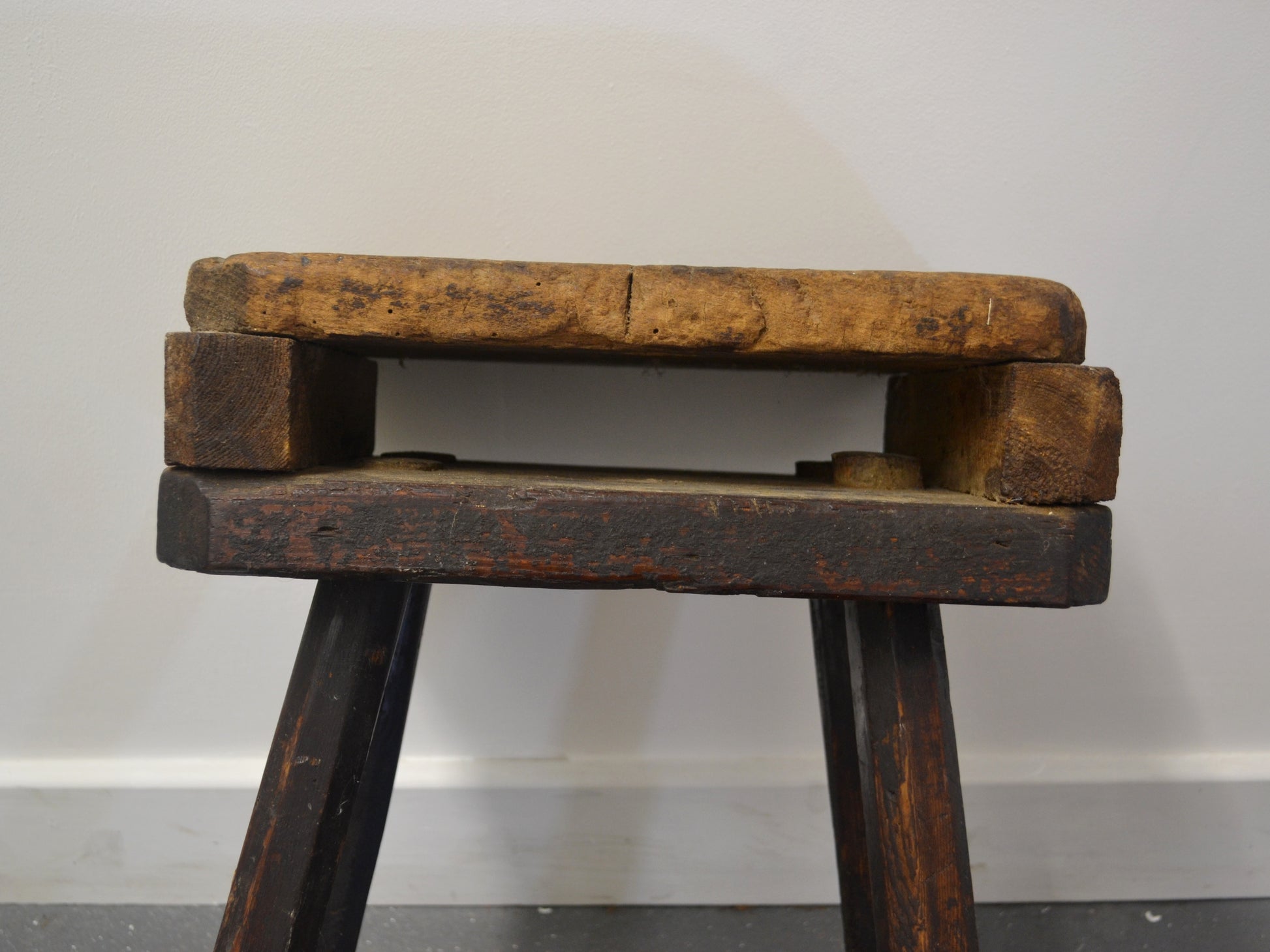 Side profile of antique English cutler's stool showing splayed leg construction and double-top, circa 1880s, workshop furniture