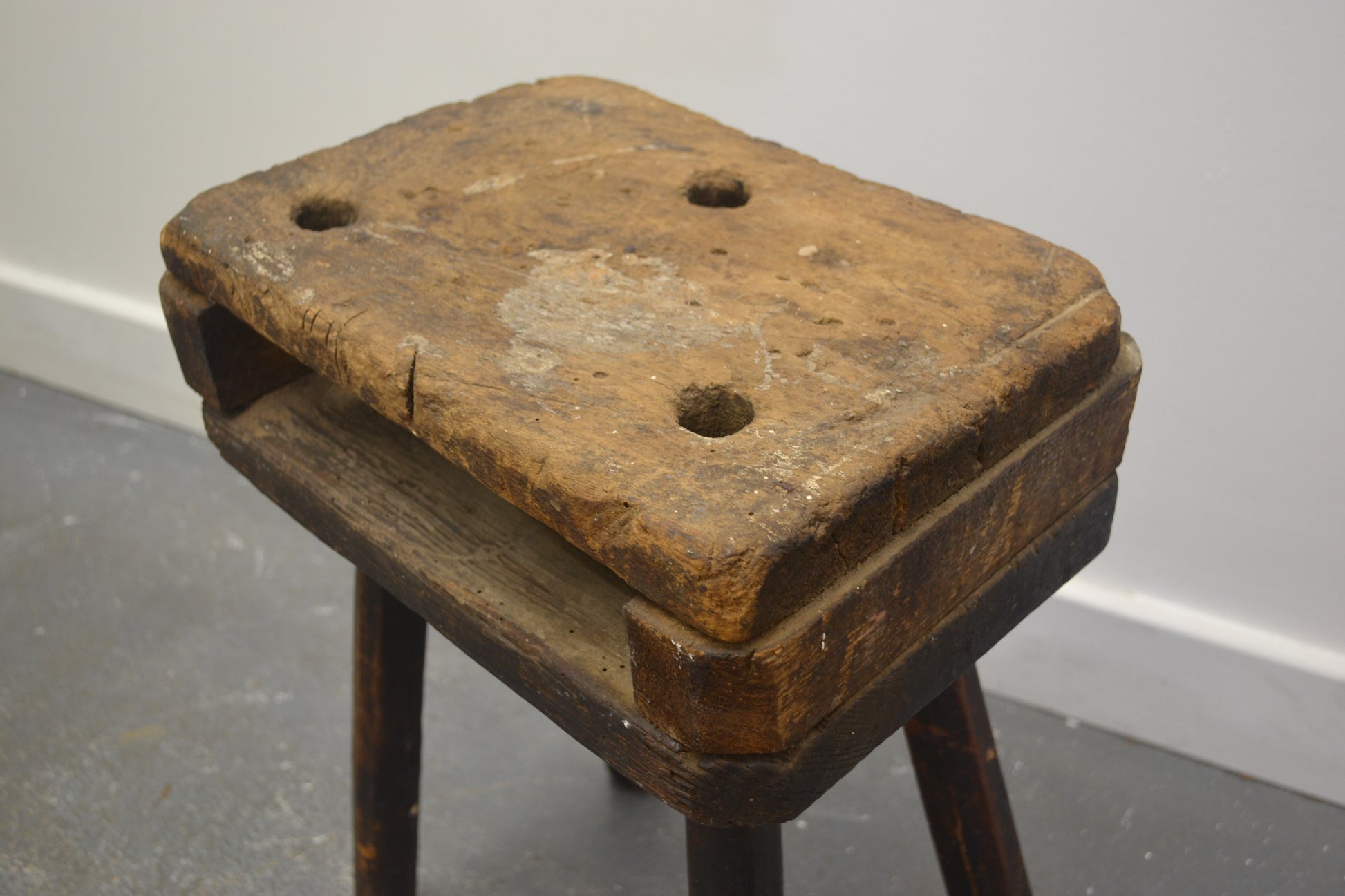 Close-up of double-plank top of antique English cutler's stool showing surface wear and honey patina, circa 1880s