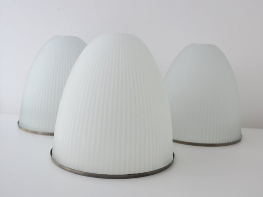 Ribbed milk glass dome pendant shades, Holophane style, mid-century modern, set of three, hero prop lighting, front view