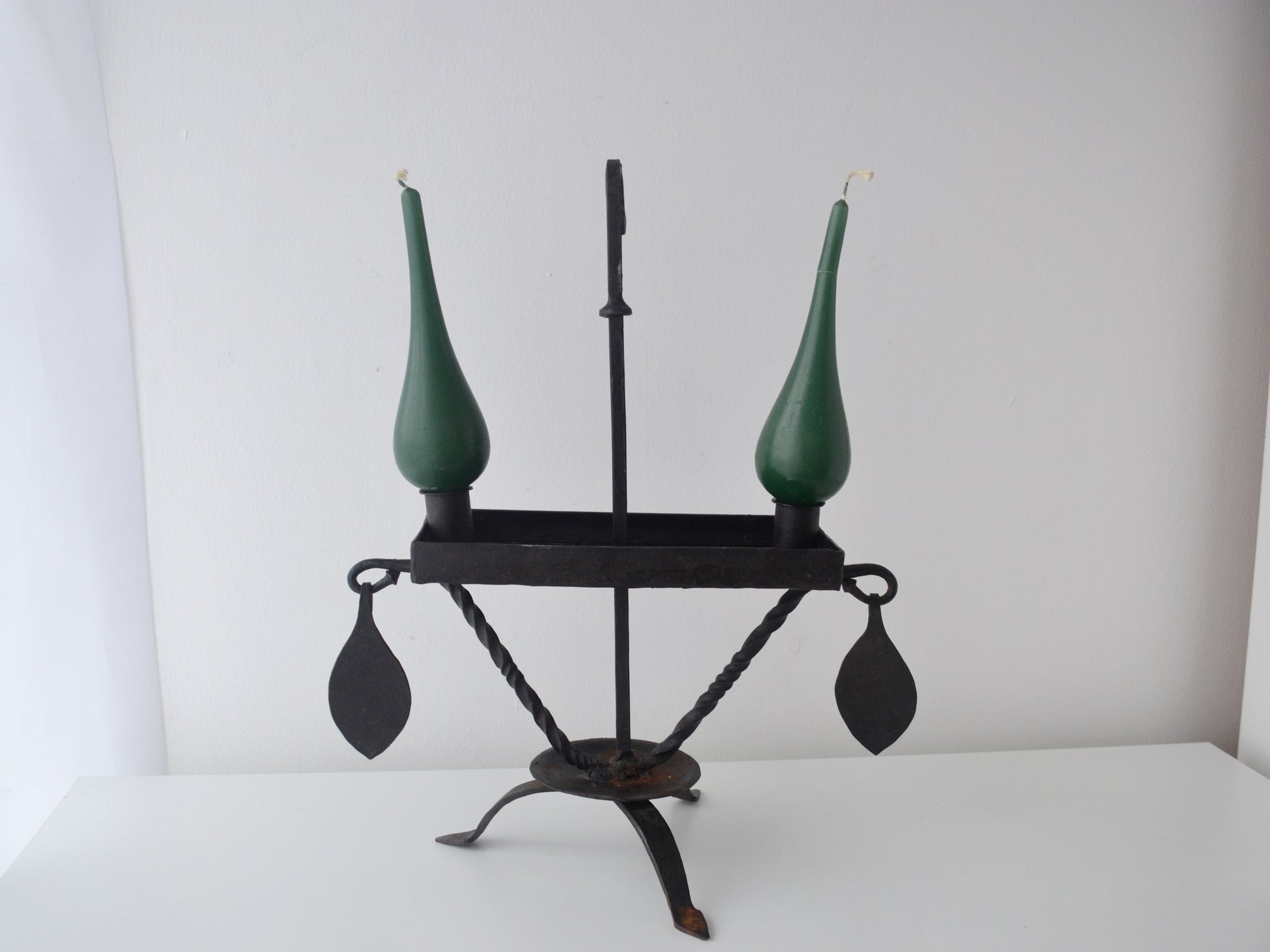 Hand-forged wrought iron candle stand, Arts & Crafts style, twisted tripod base, hanging leaf pendants, front view