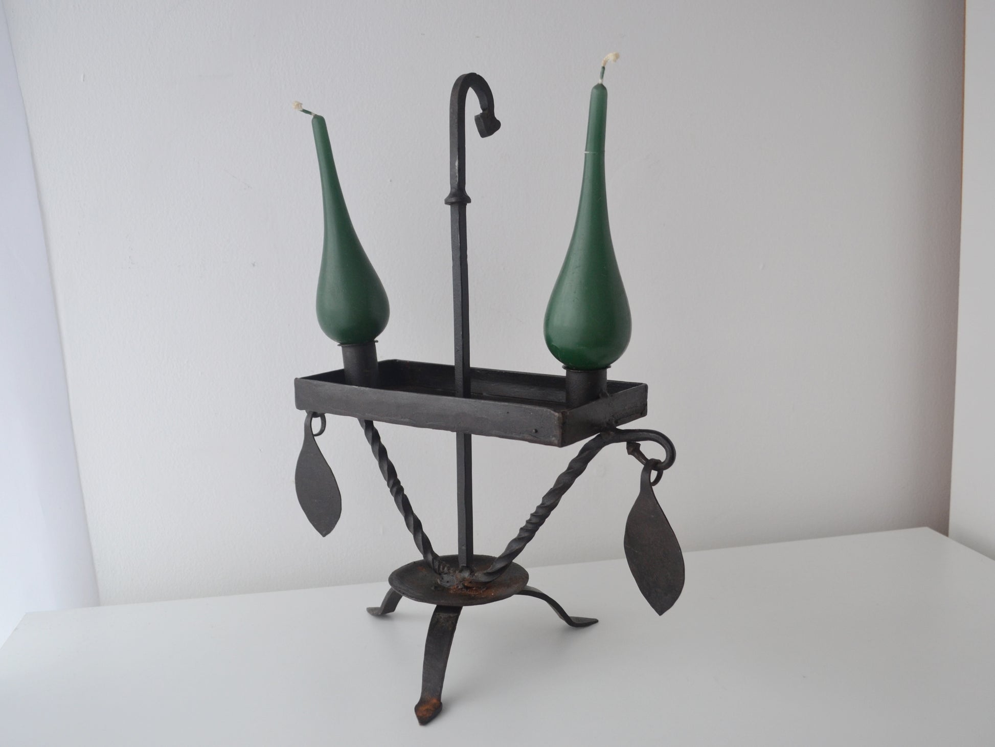 Hand-forged wrought iron candle stand, Arts & Crafts style, twisted legs and rectangular drip tray, side view