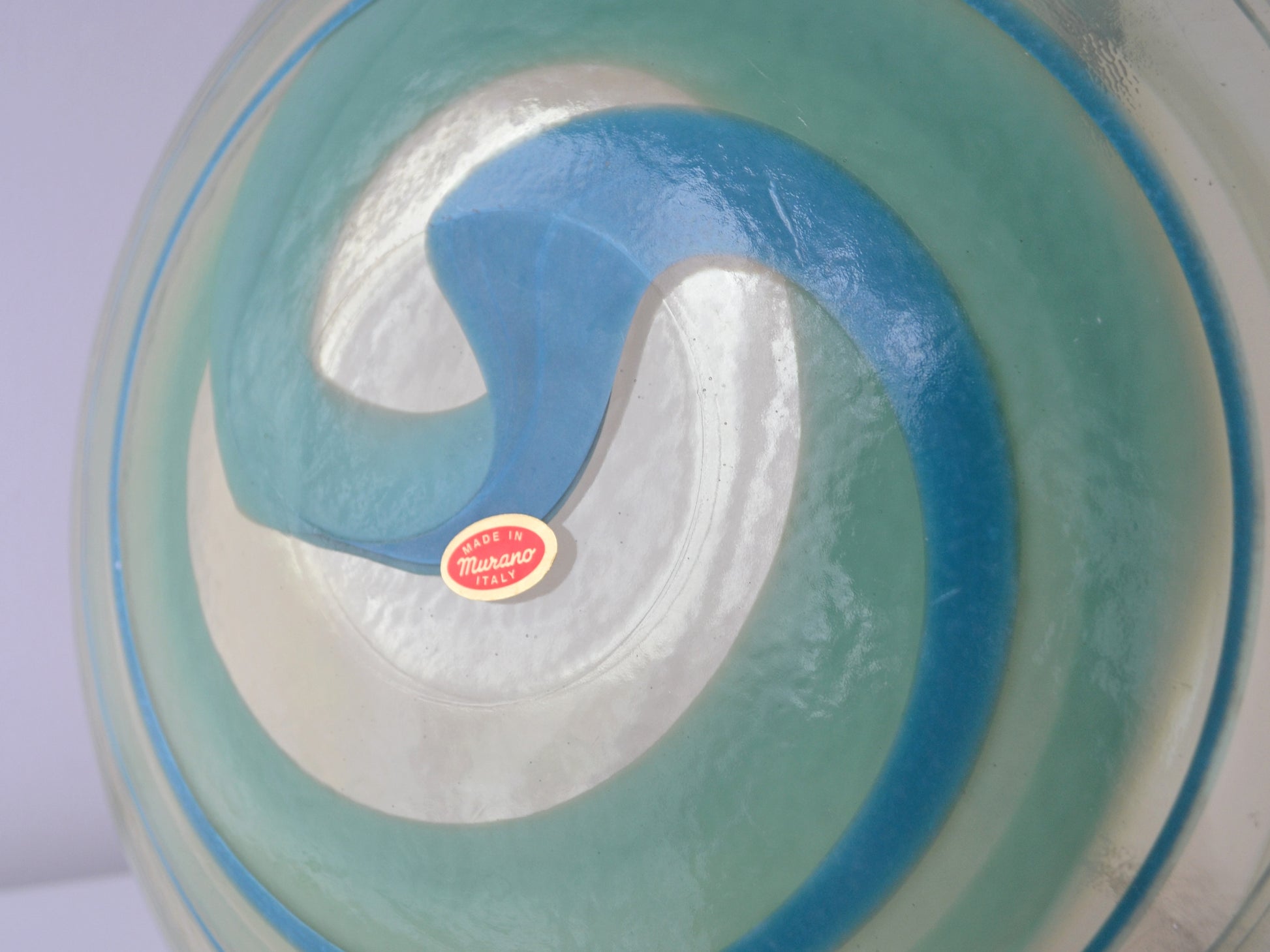 Underside of Murano glass centrepiece bowl showing original Made in Murano Italy label, aqua teal spiral design, circa 1970s
