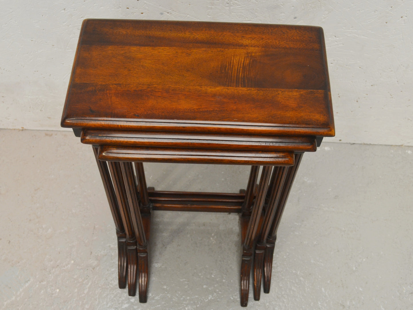 Theodore Alexander mahogany nest of three Regency-style tables, front view.