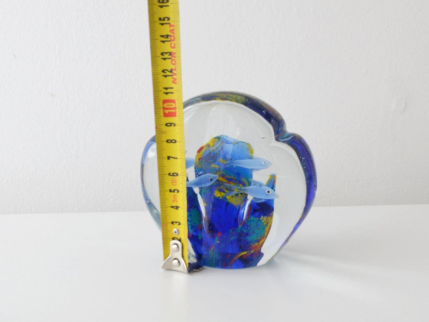 Detail of hand blown fish figures suspended in Murano style art glass aquarium block.