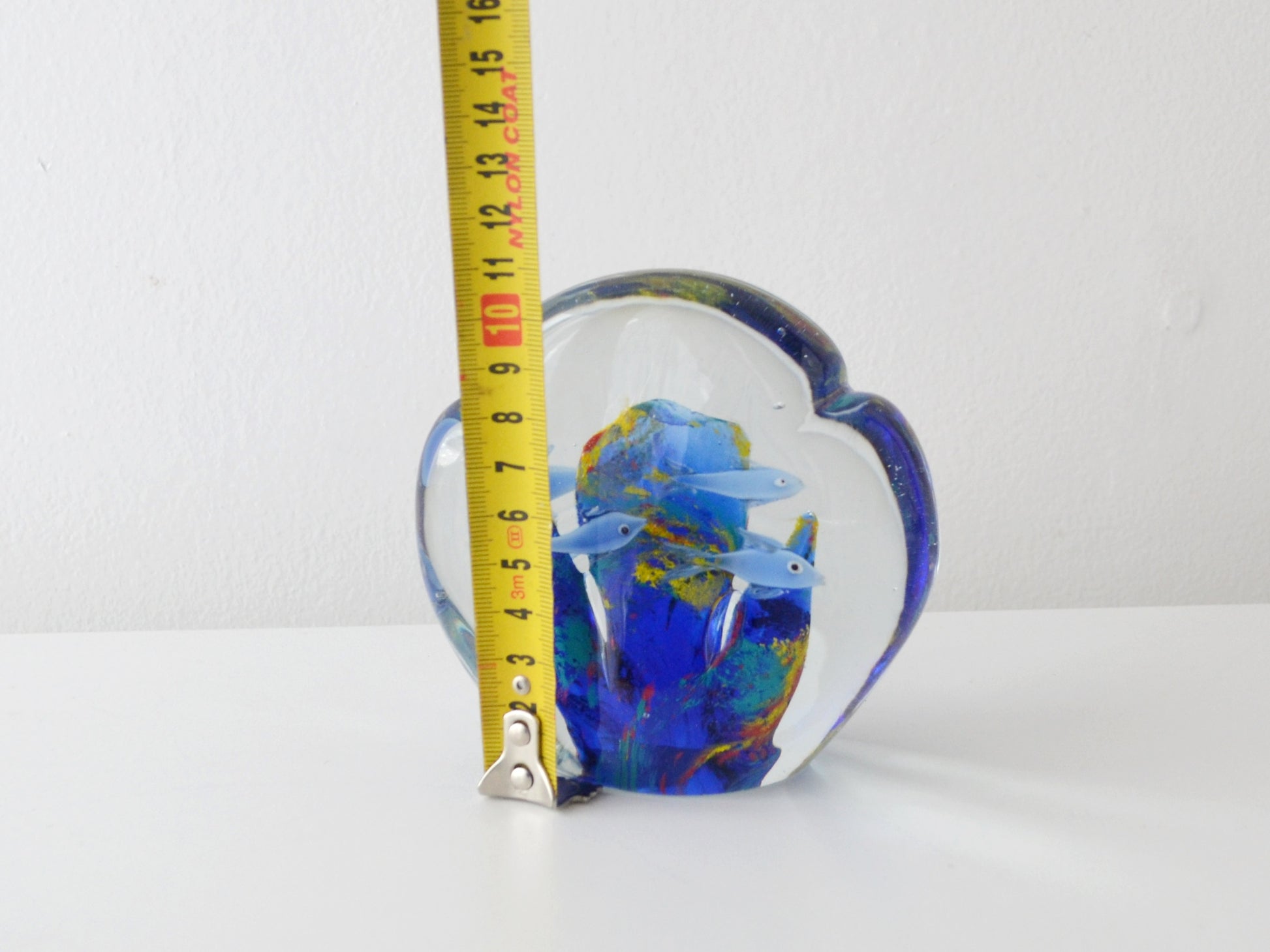 Detail of hand blown fish figures suspended in Murano style art glass aquarium block.