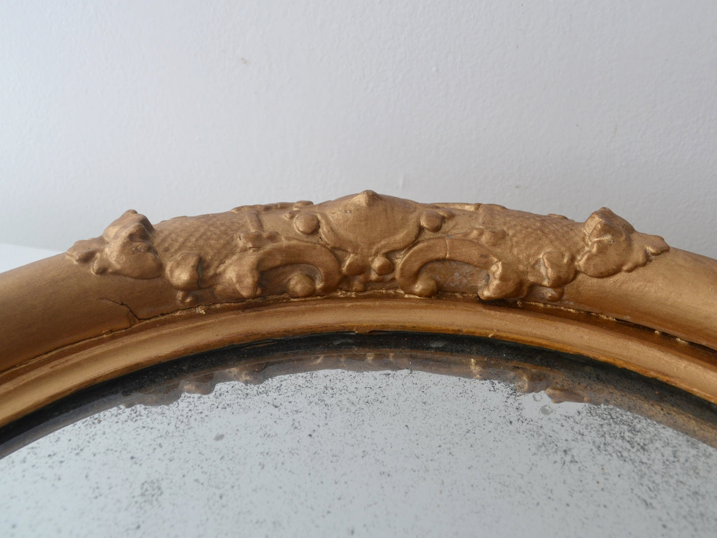 Ornate gesso barbola decoration detail on Victorian gilt round mirror frame England circa 1880
