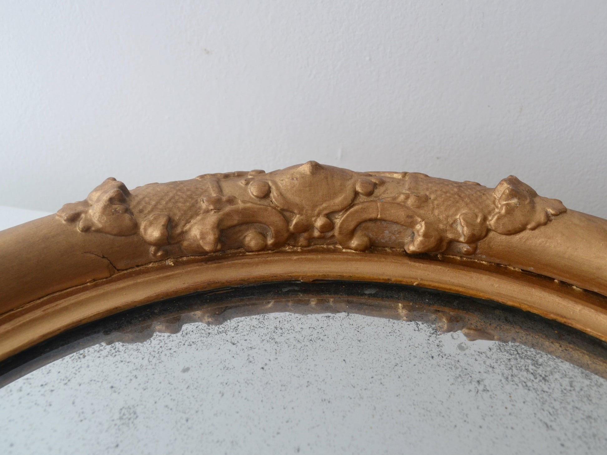 Ornate gesso barbola decoration detail on Victorian gilt round mirror frame England circa 1880