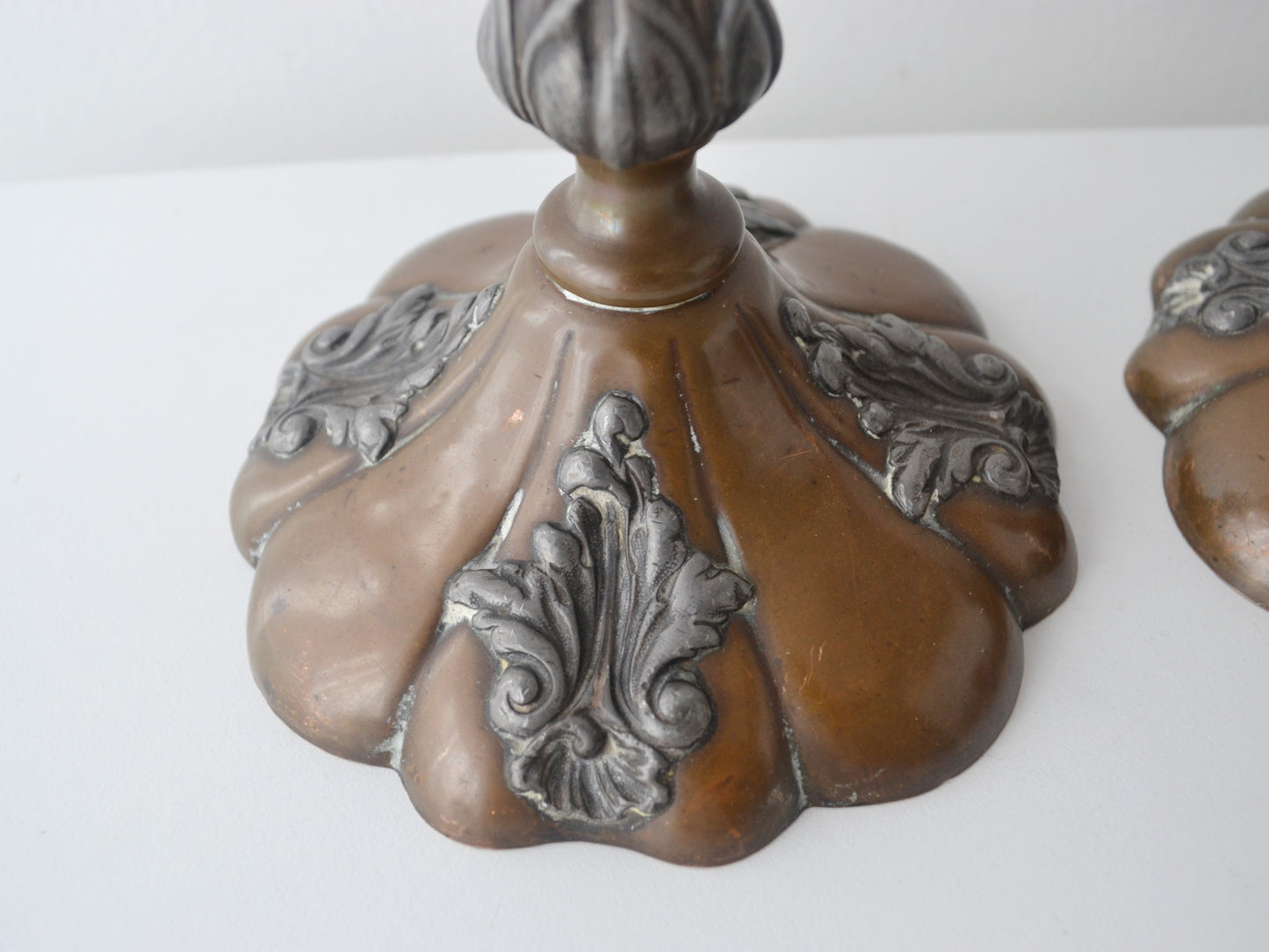 Silver mounted acanthus cartouche detail on Victorian copper candlestick base, circa 1890
