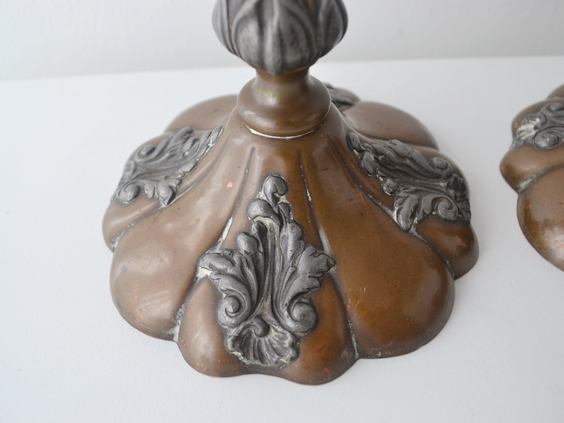 Silver mounted acanthus cartouche detail on Victorian copper candlestick base, circa 1890