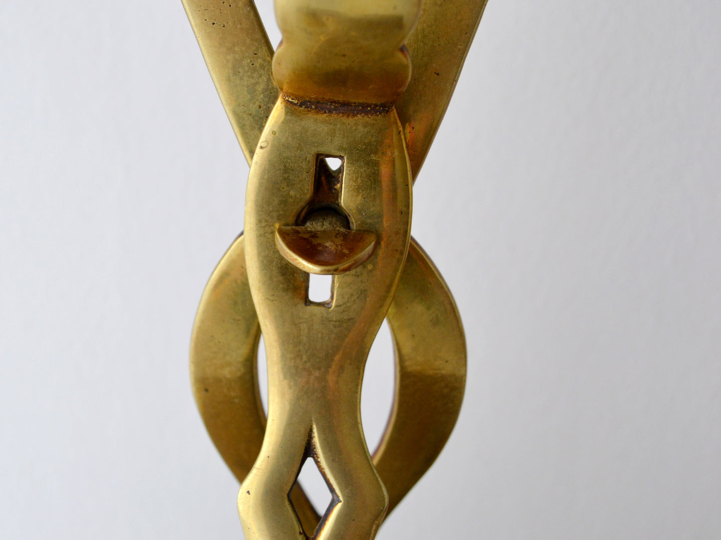 Twisted openwork handle detail of antique brass chestnut roaster, circa 1900s.
