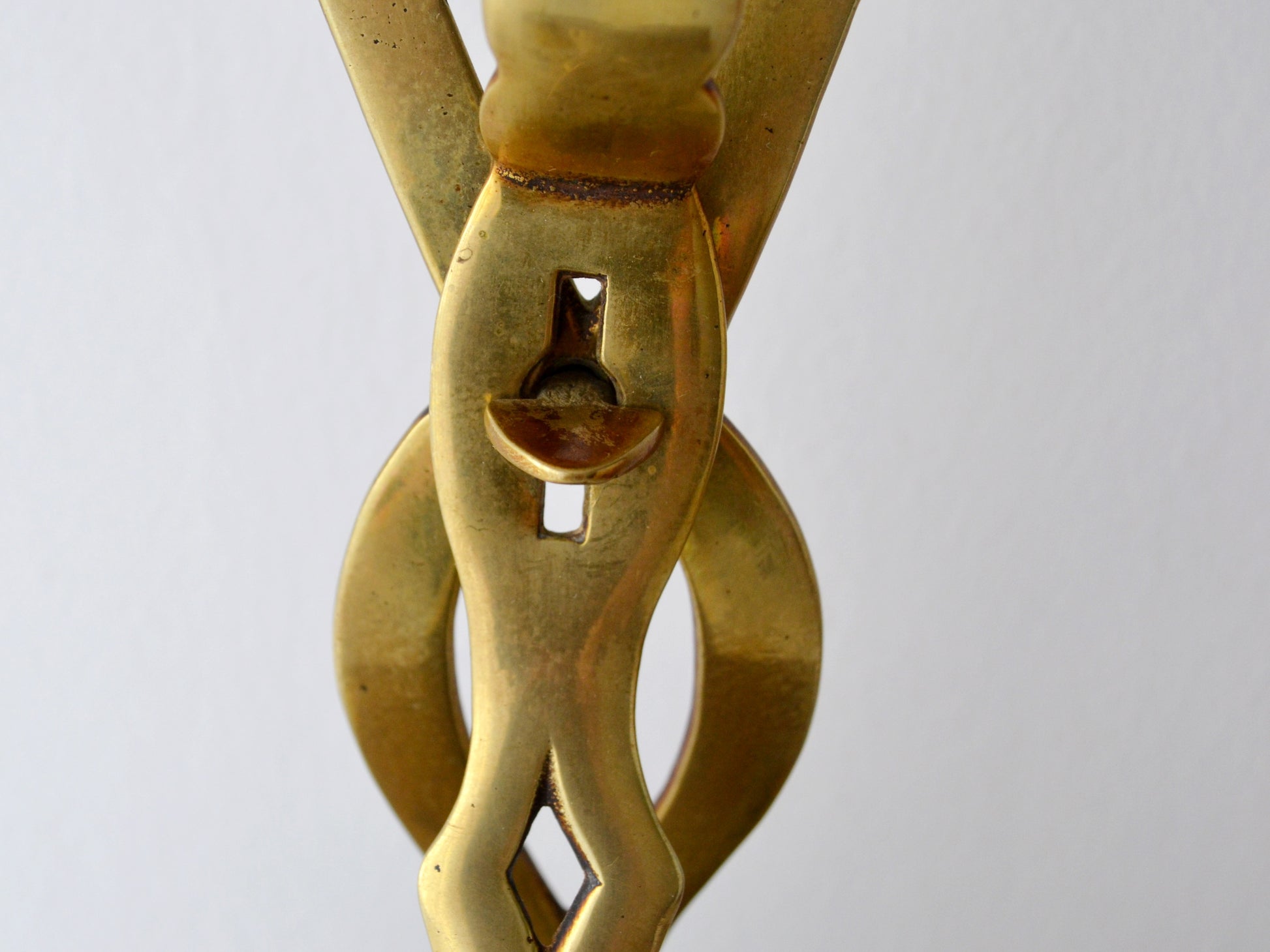 Twisted openwork handle detail of antique brass chestnut roaster, circa 1900s.