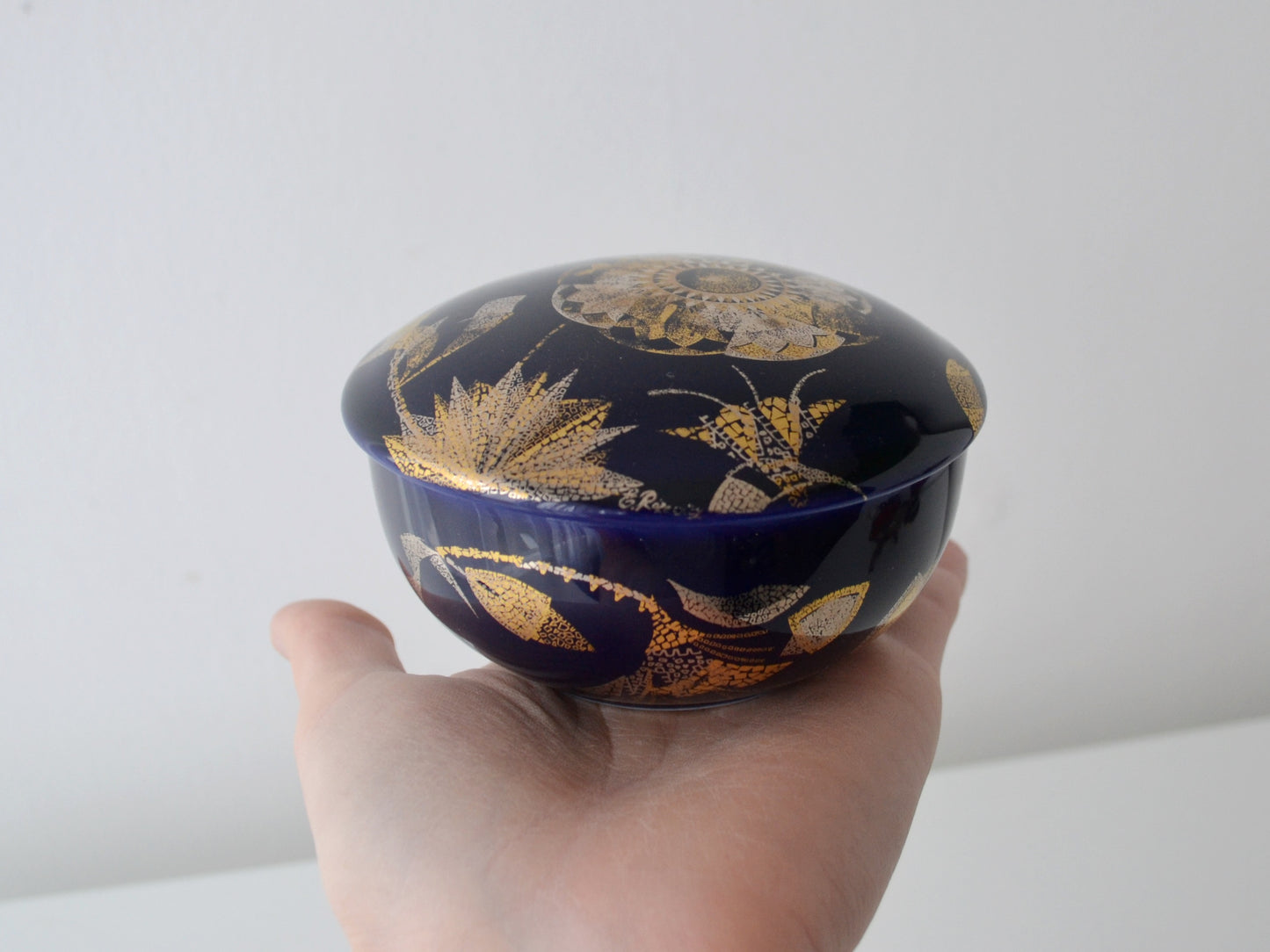 Gold botanical and insect decoration detail on Manufacture de Monaco cobalt blue porcelain box Design de Rayons