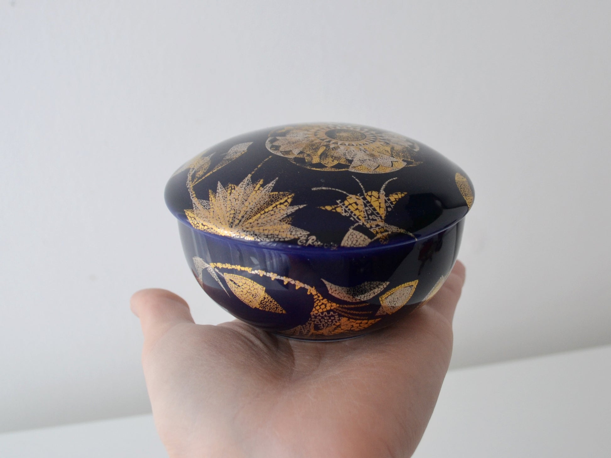 Gold botanical and insect decoration detail on Manufacture de Monaco cobalt blue porcelain box Design de Rayons