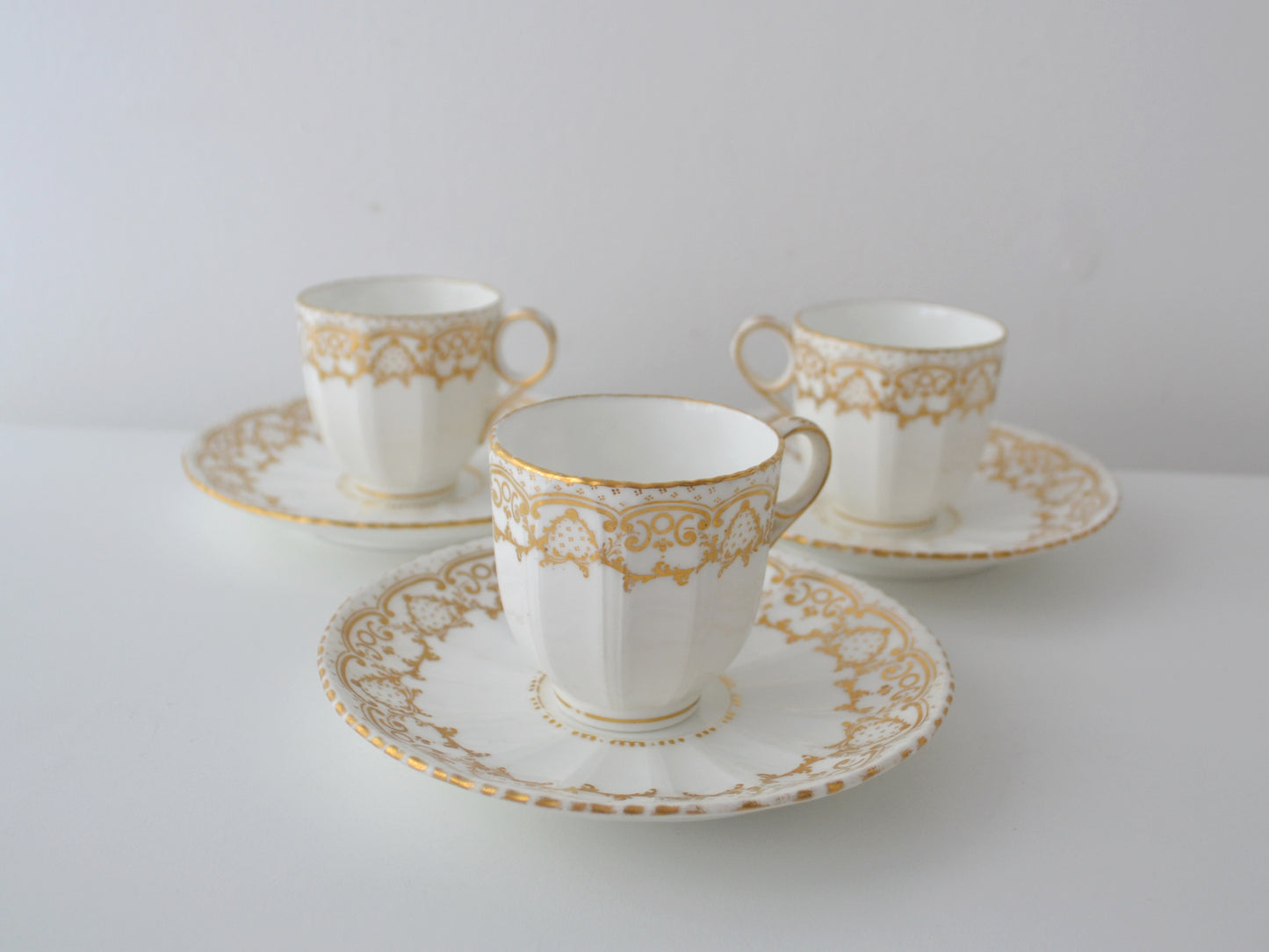 Davenport Longport Staffordshire porcelain trio set of three, gilt scrollwork, England circa 1800-1830, front view