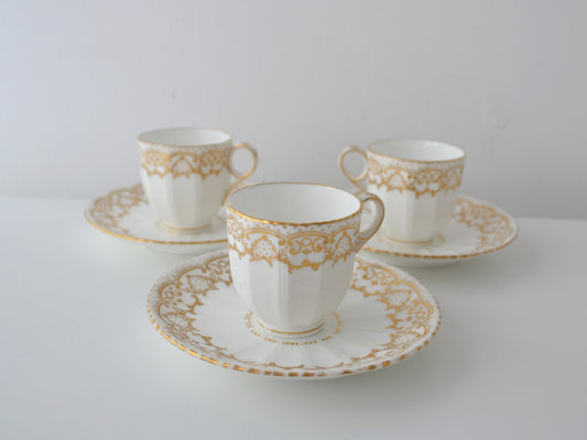 Davenport Longport Staffordshire porcelain trio set of three, gilt scrollwork, England circa 1800-1830, front view