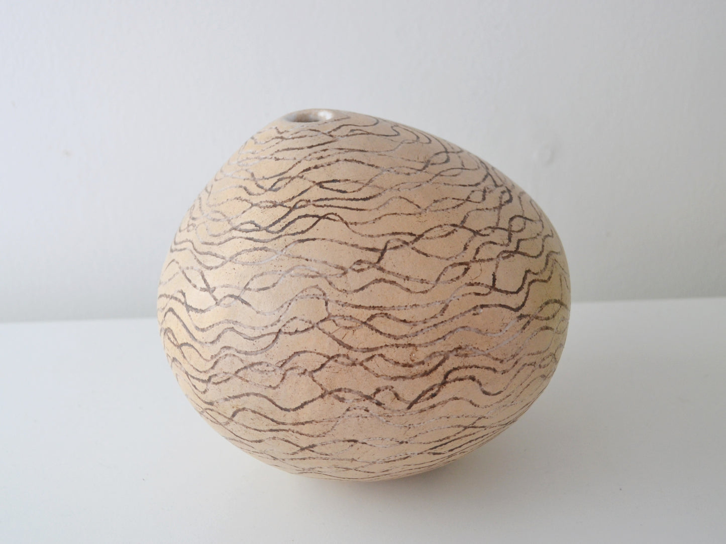 Sgraffito stoneware globe weed pot, European studio pottery, mid-late 20th century, front view.