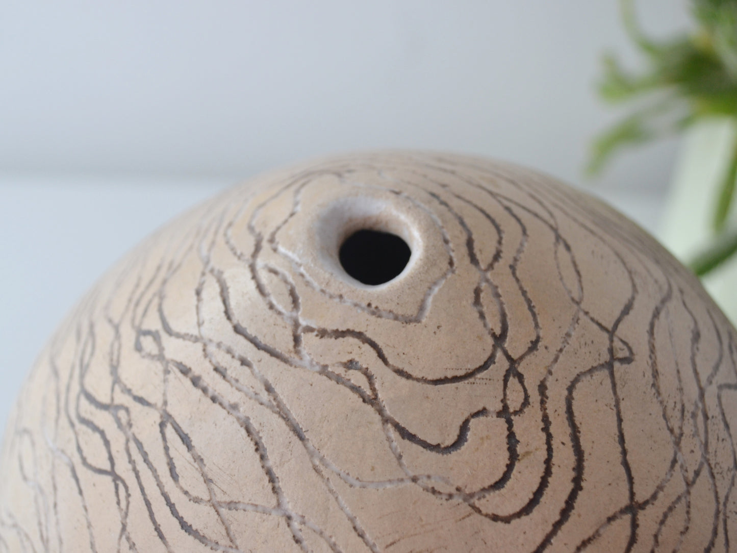 Sgraffito wave line surface detail, stoneware globe weed pot, European studio pottery mid-late 20th century.