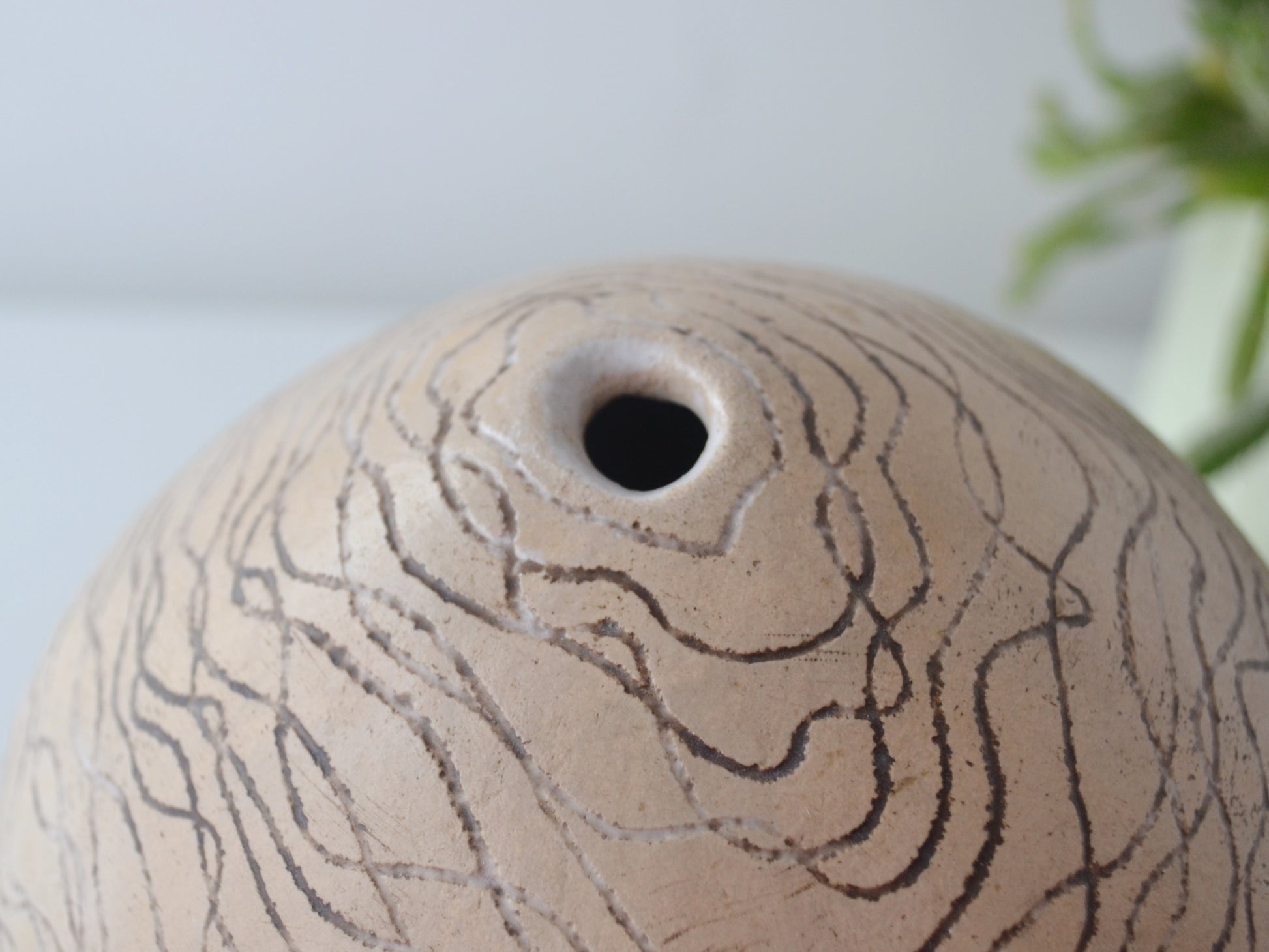 Sgraffito wave line surface detail, stoneware globe weed pot, European studio pottery mid-late 20th century.