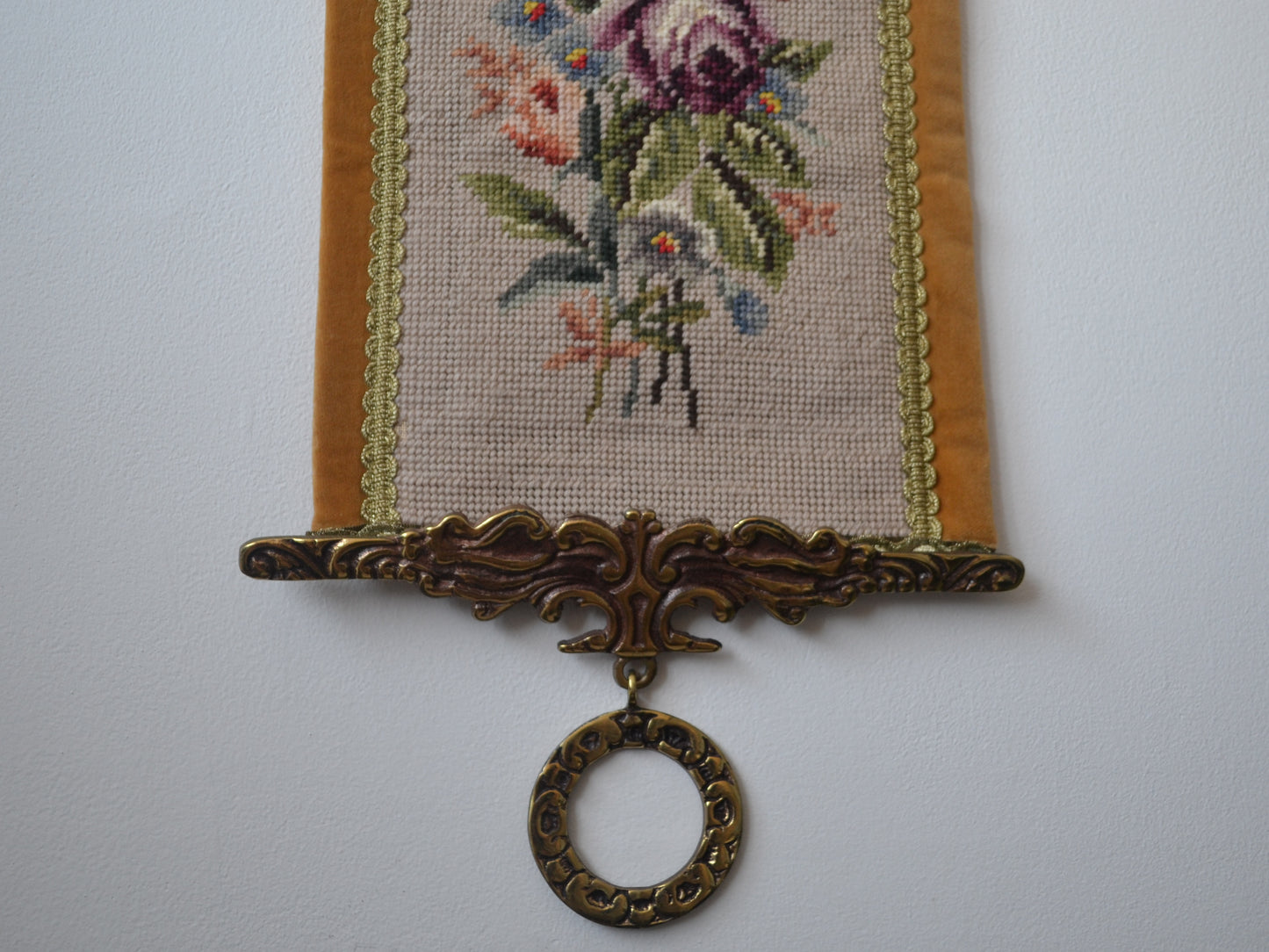 Cast brass lower weighted ring, West German needlepoint bell pull, circa 1950s–60s.