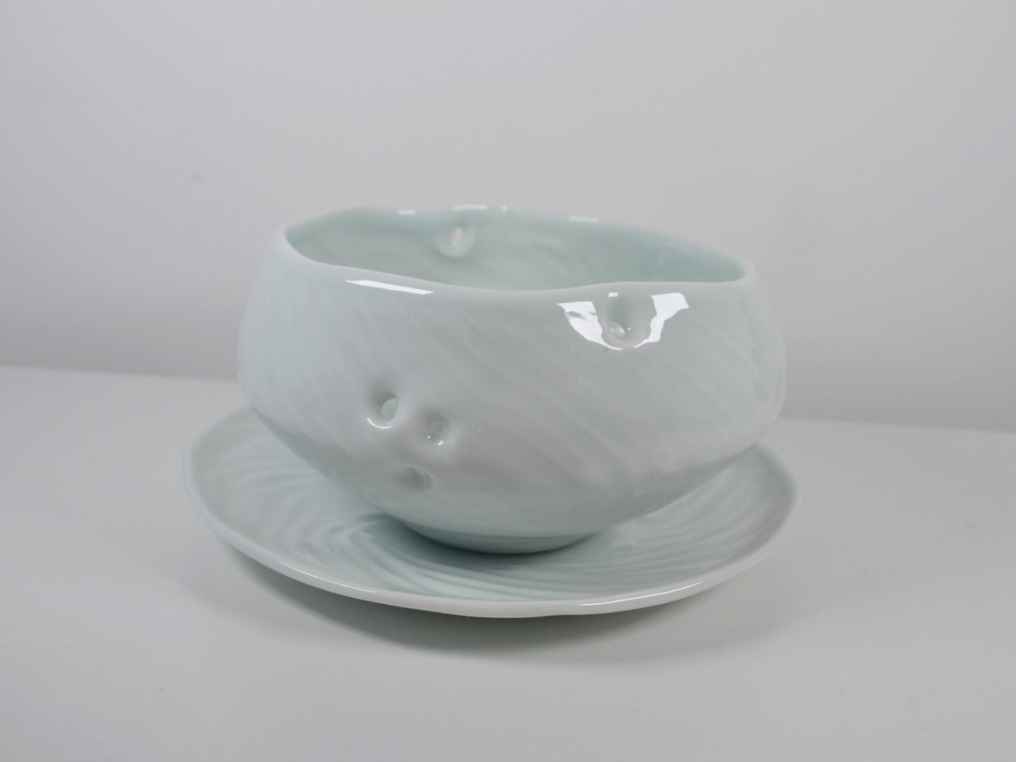 Joanna Howells celadon porcelain plate with swirl relief and organic rim, Wales circa 2000s.