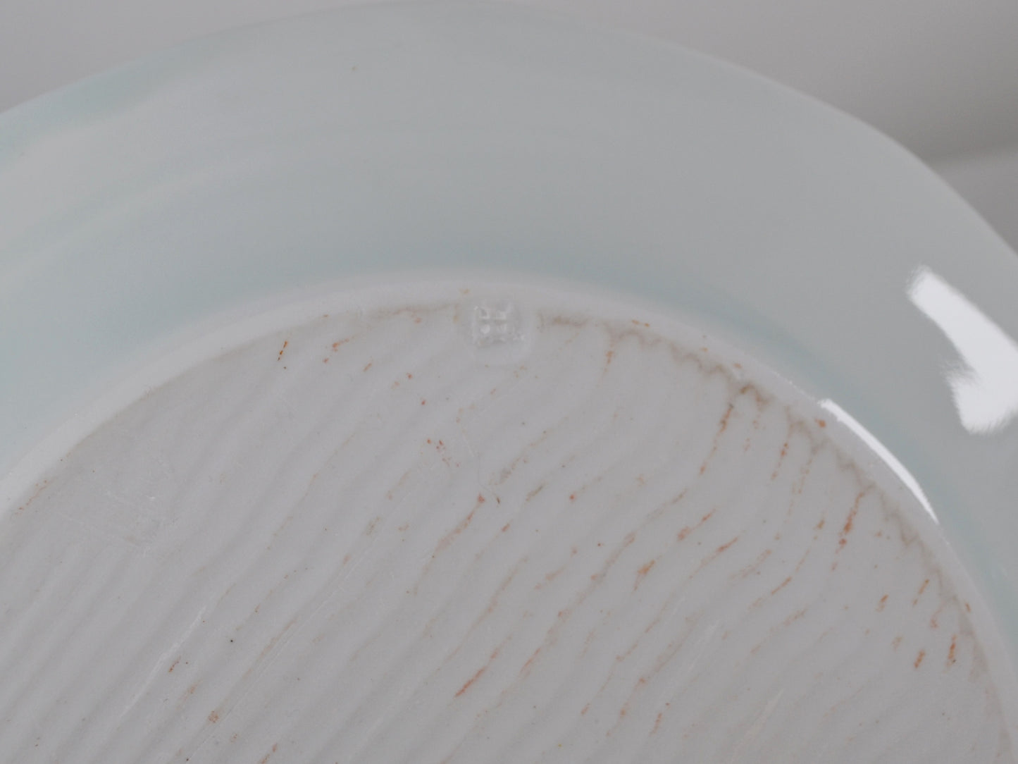 Impressed JH maker's mark on base, Joanna Howells celadon porcelain plate, Wales circa 2000s.