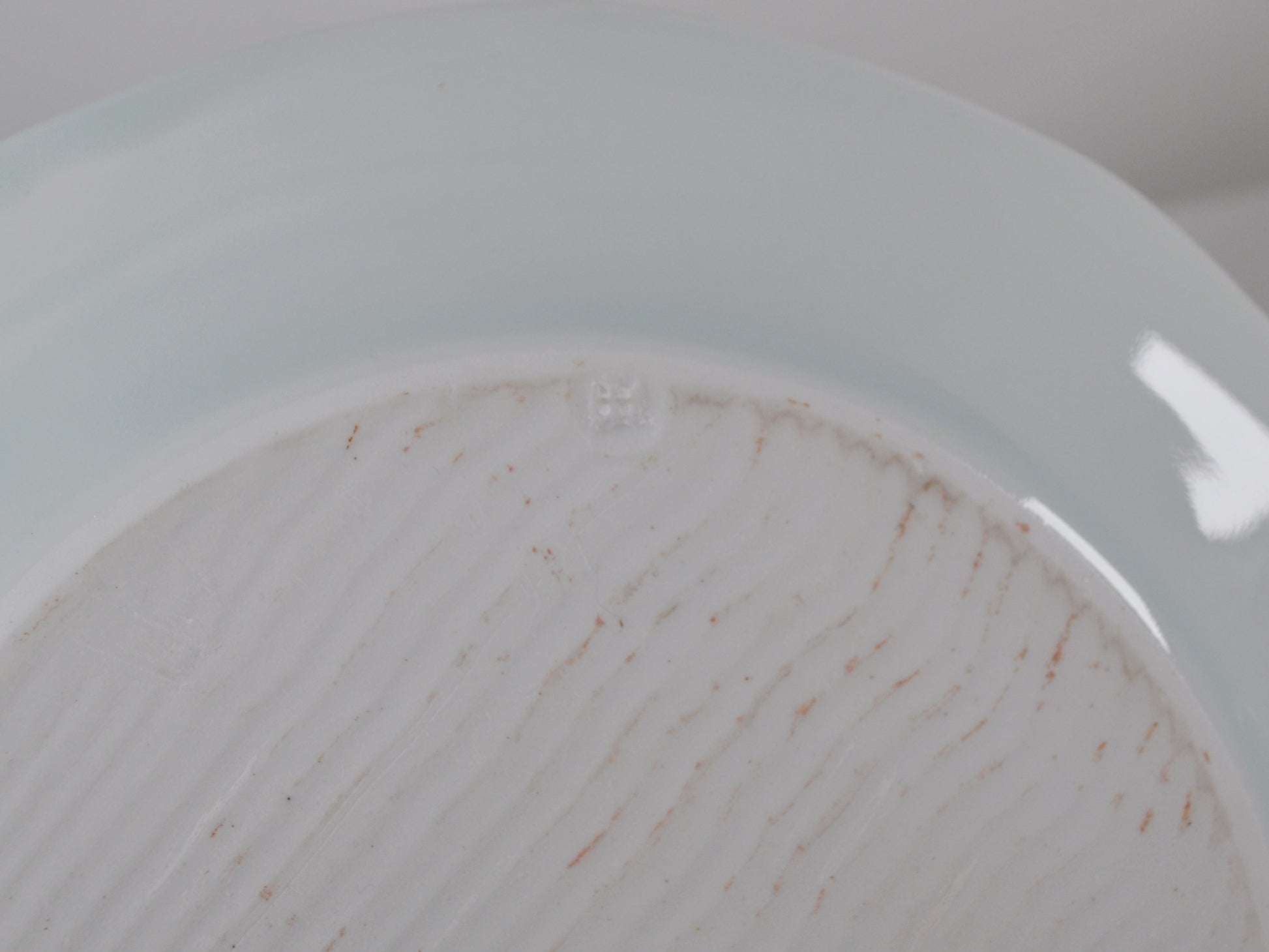 Impressed JH maker's mark on base, Joanna Howells celadon porcelain plate, Wales circa 2000s.