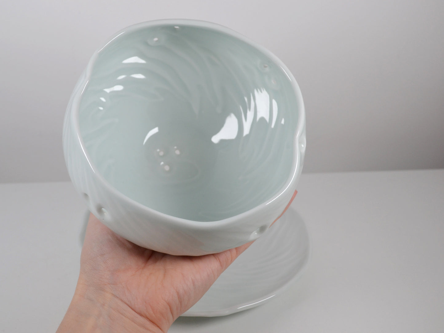 Joanna Howells celadon porcelain berry bowl and plate set, side view, Wales circa 2000s.