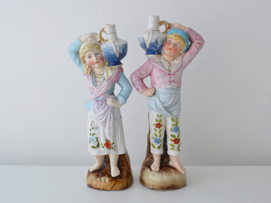 Matched pair Bohemian porcelain water carrier figurines, Elbogen circa 1880s, hand-painted pastoral costume, front view