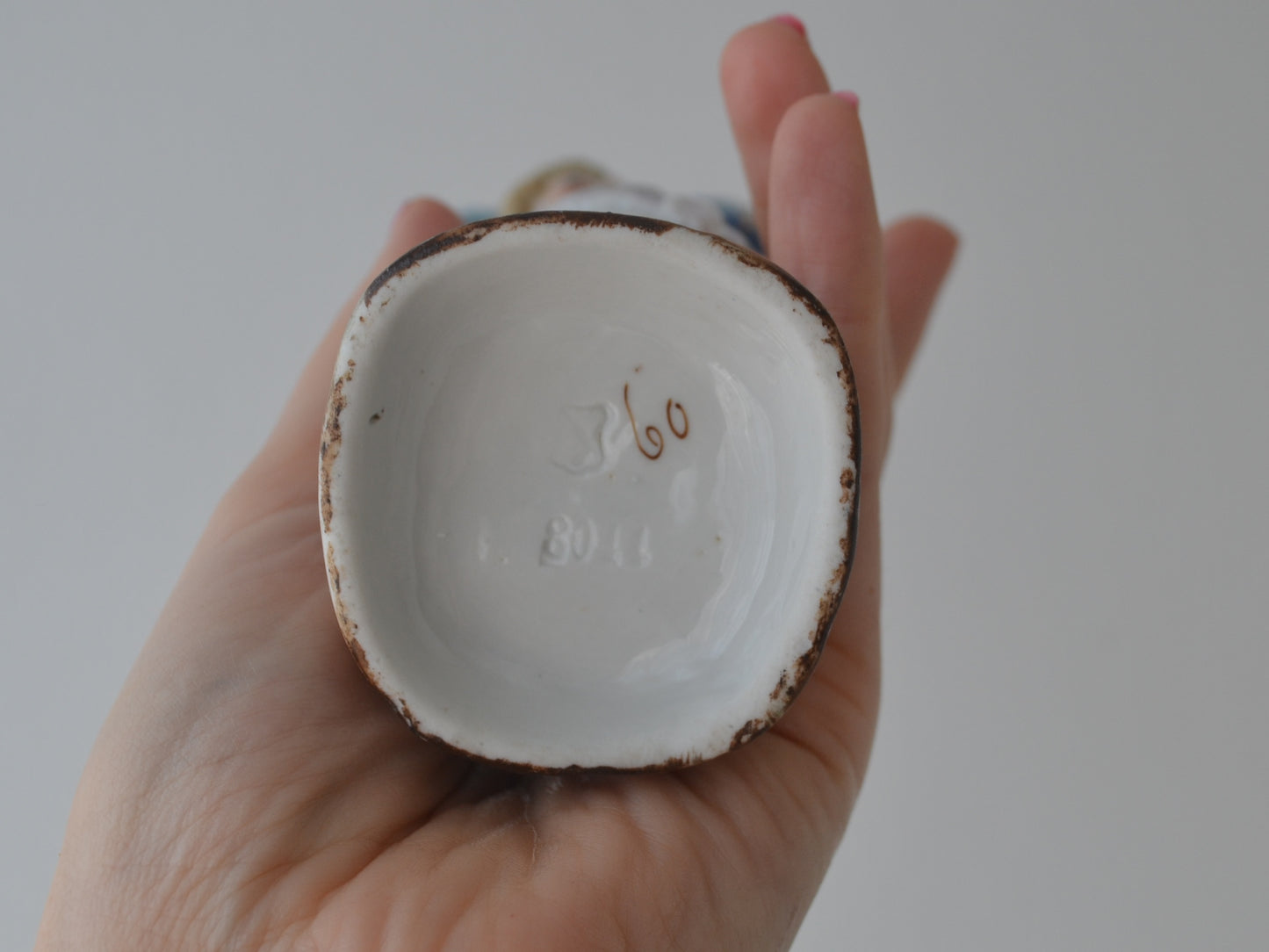 Base of Bohemian porcelain figurine showing impressed mould number 8044 and painted decorator's number 60, Elbogen circa 1880s