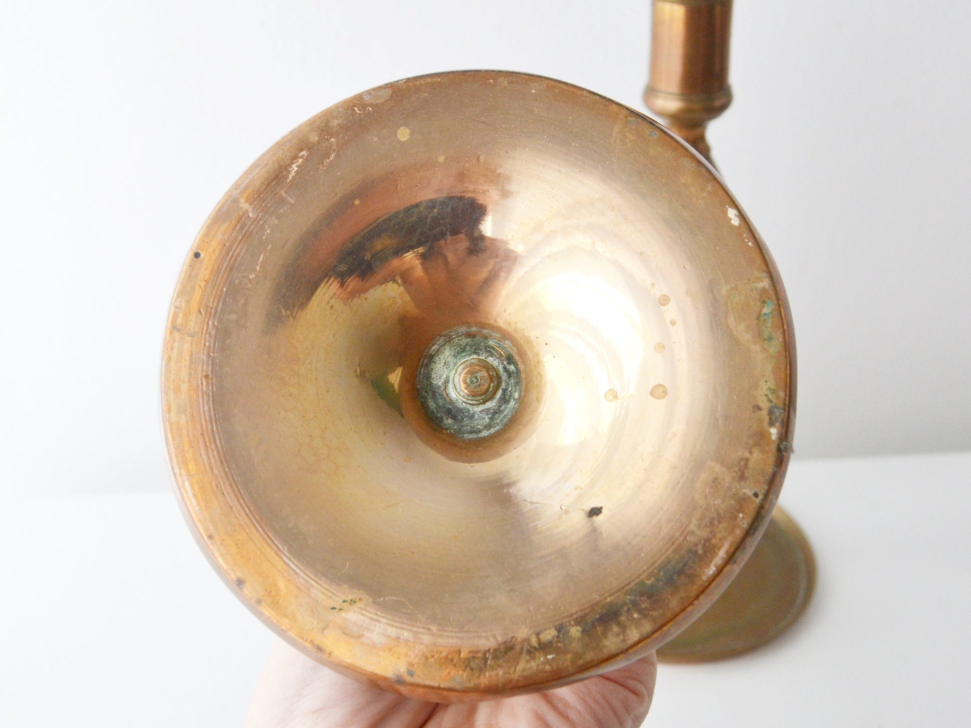 Base underside of antique brass candlestick, hand-turned concentric rings, sand-cast surface, original hand-cut thread with verdigris, circa 1780–1840