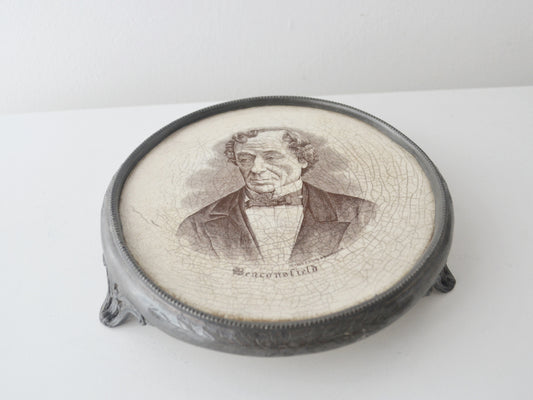 Victorian Disraeli commemorative teapot stand, Deykin &amp; Sons Birmingham circa 1881, black transfer portrait, beaded white metal frame, brass feet, front view
