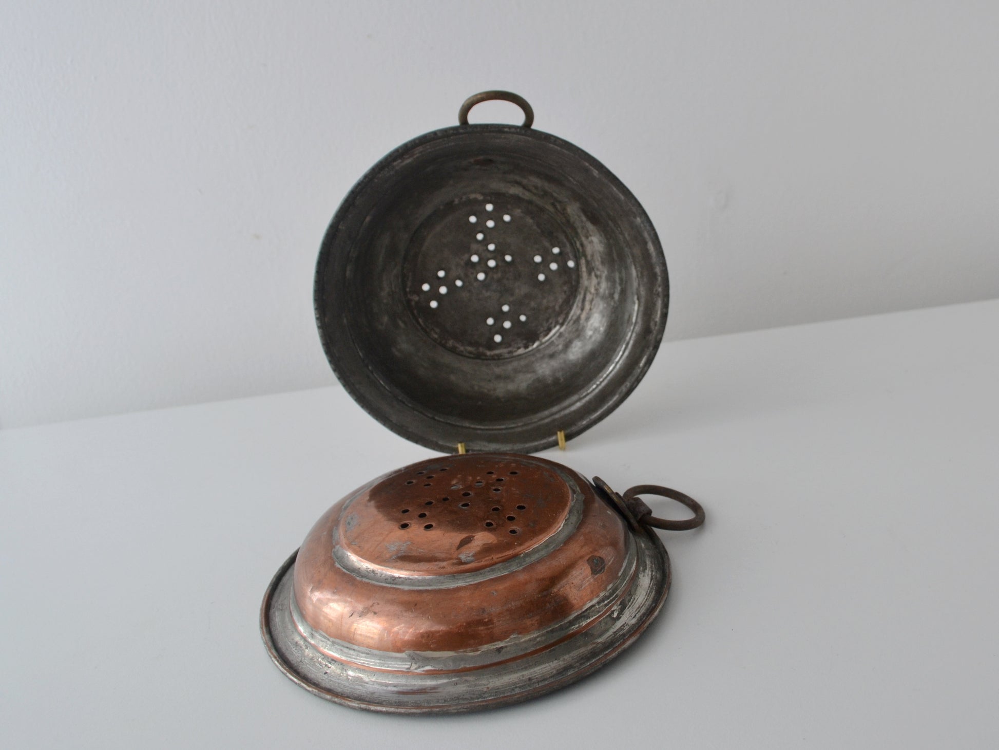 Pair of antique French copper colanders, tinned interior, ring handles, circa 19th century, front view.