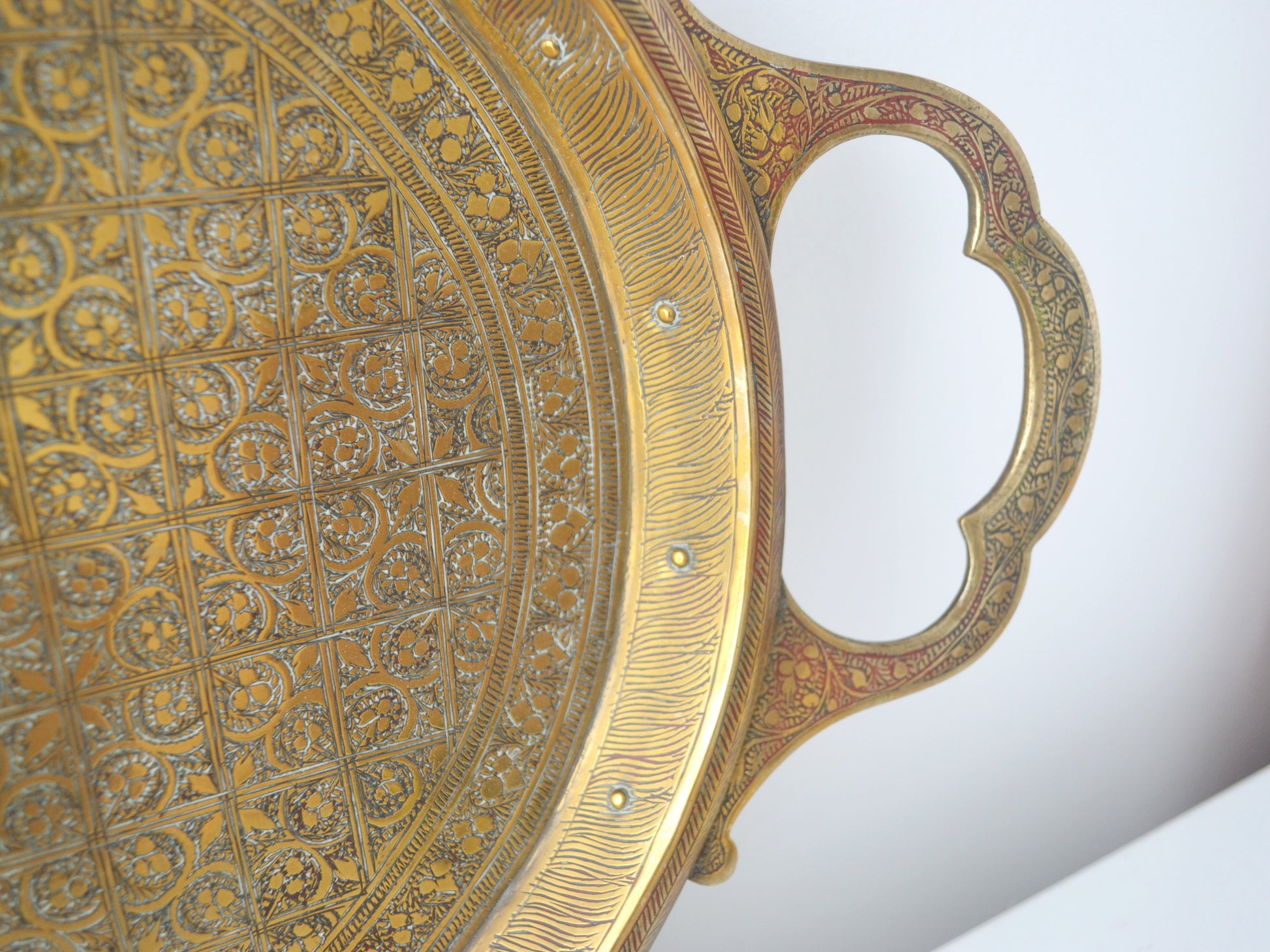 Close detail of hand-engraved peacock tail feathers, brass tray, Kashmir export brassware circa 1880–1910