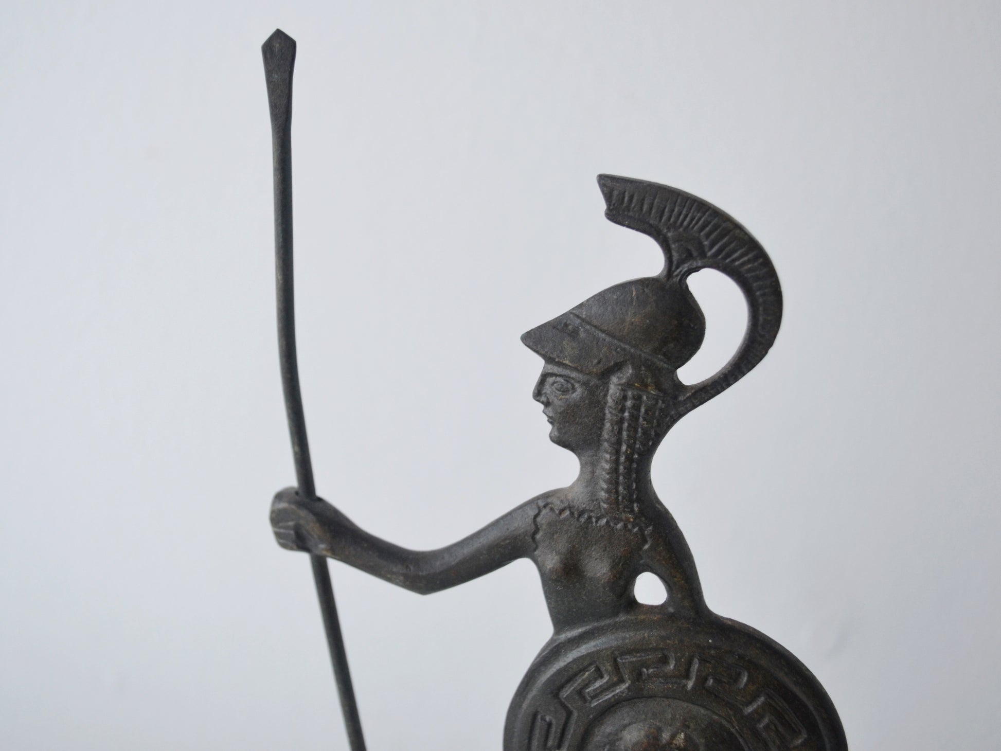 Detail of crested helmet and face on vintage cast bronze Athena figurine, Greece circa 1960s