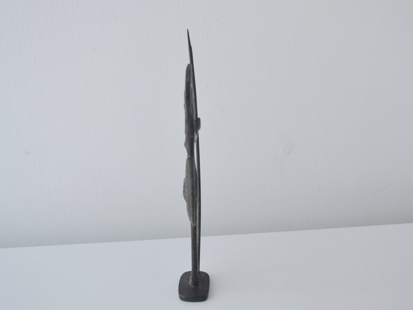 Side profile of cast bronze Athena figurine showing flat casting tradition, Greece circa 1960s