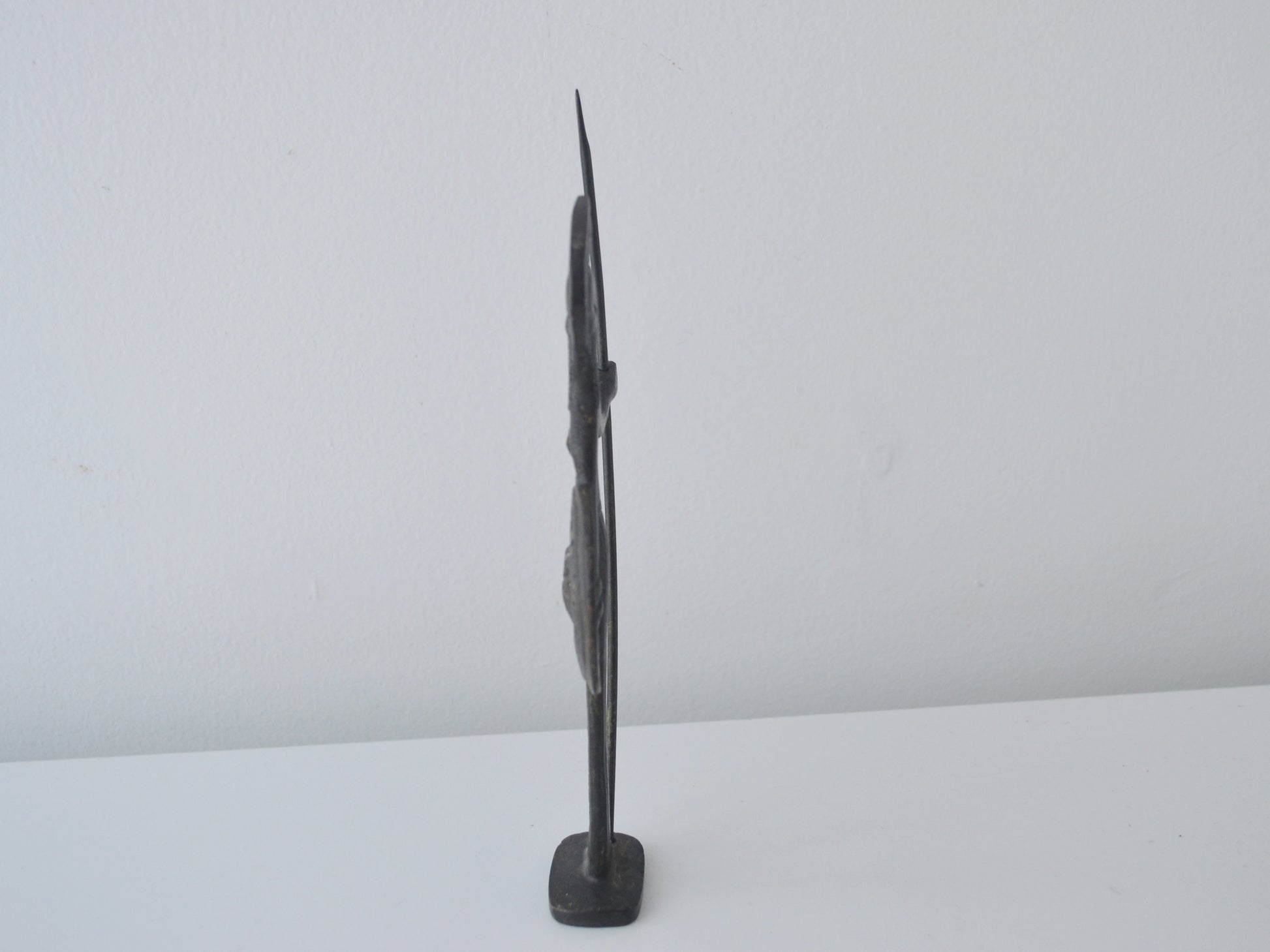 Side profile of cast bronze Athena figurine showing flat casting tradition, Greece circa 1960s