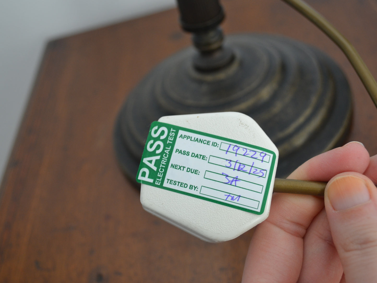 Inline rocker switch on brass-finish cord of adjustable swan neck table lamp, PAT tested December 2025.