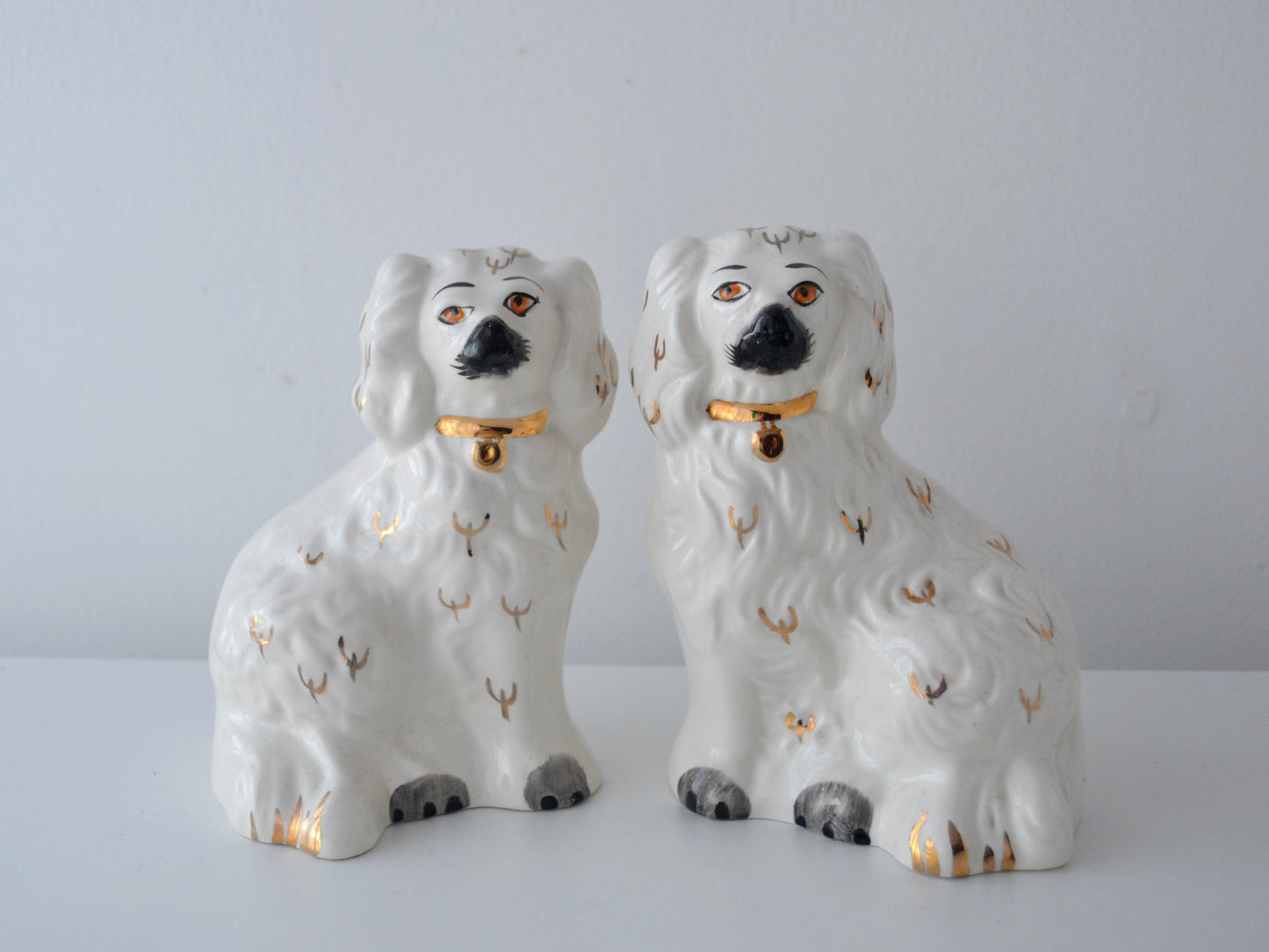 Pair of Beswick Staffordshire spaniel dogs, gilt collars, front view.