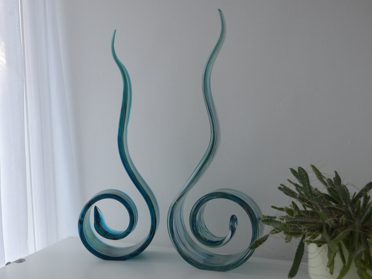 Hand-blown aqua glass swirl sculptures, Italian Murano style, pair, circa 1990s, sinuous spiral form, front view.