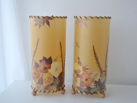 Pair pressed flower parchment lampshades with leather whipstitch and wooden feet, France Italy circa 1970s, front view.