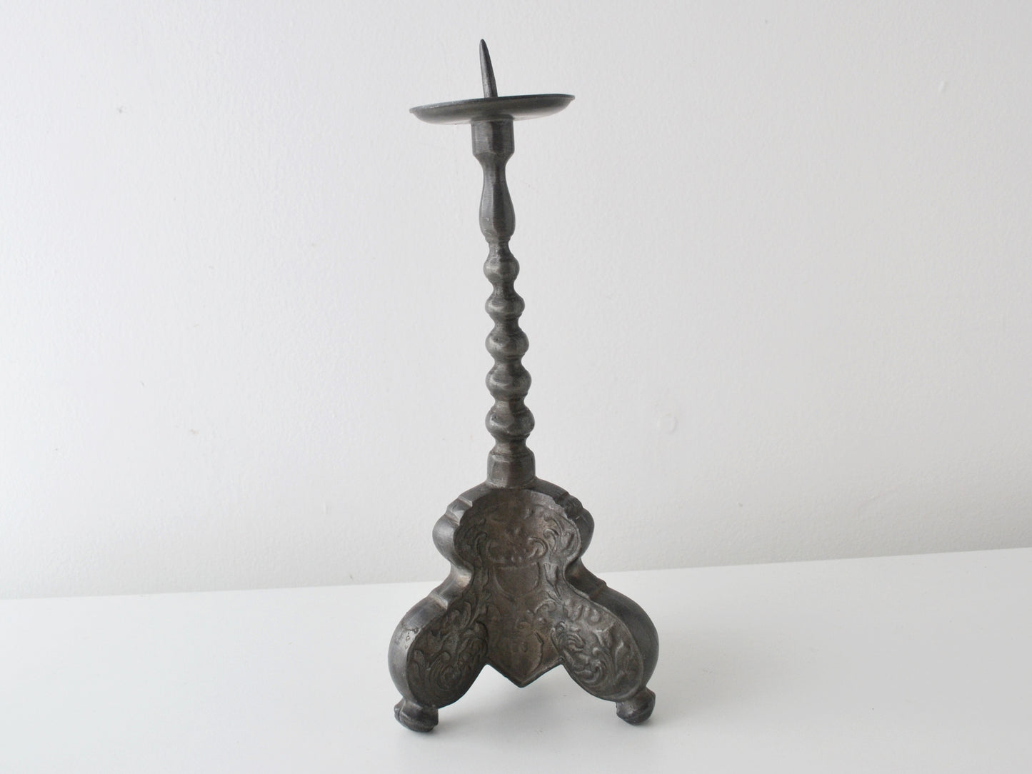 Baroque pewter pricket candlestick, tripod acanthus base, Europe circa 18th–19th century, front view.