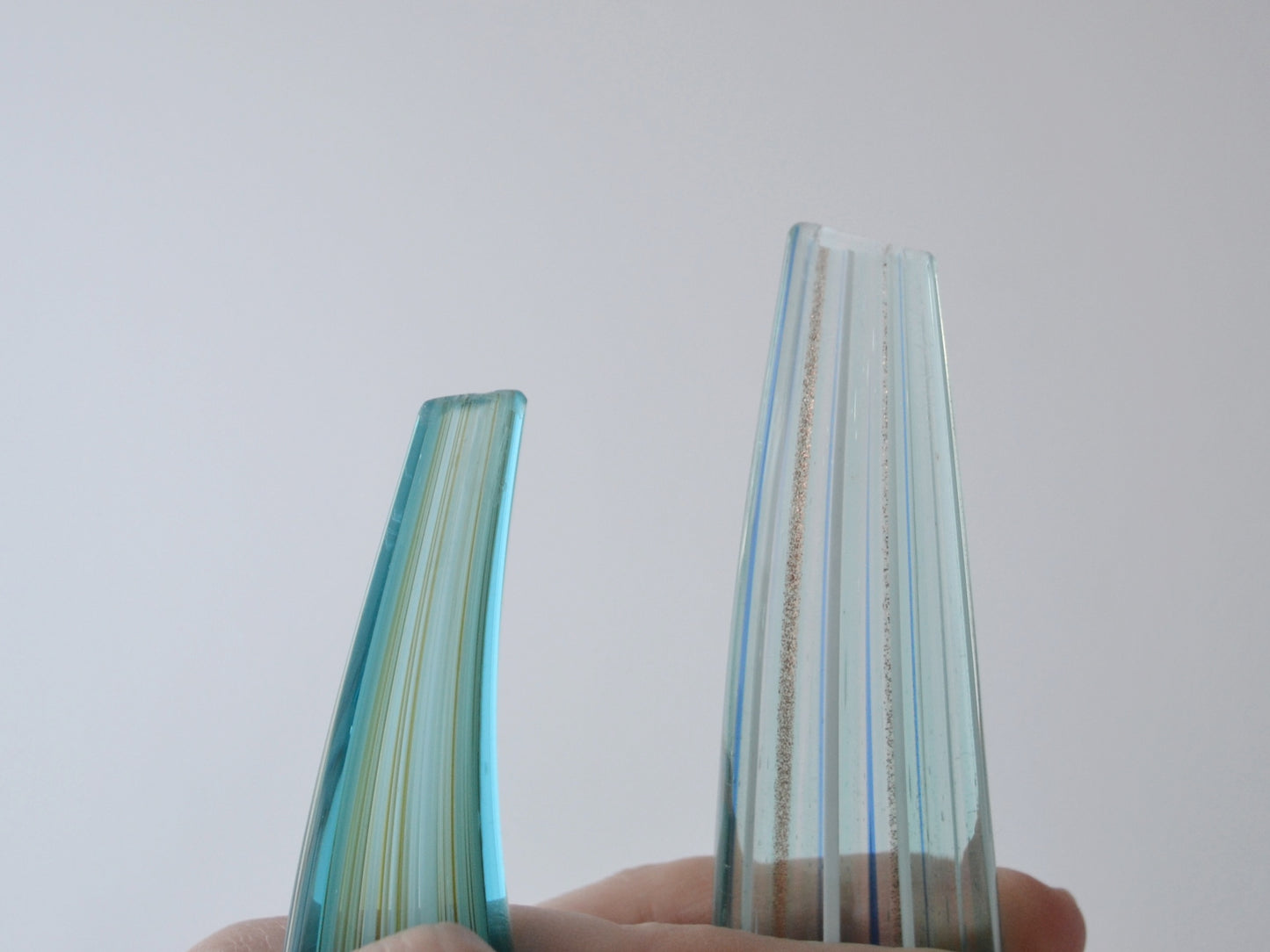 Ground and smoothed tips of hand-blown aqua glass swirl sculptures, condition visible in listing photos.