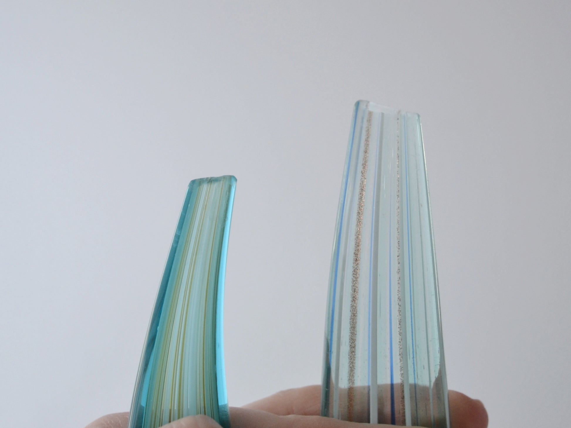 Ground and smoothed tips of hand-blown aqua glass swirl sculptures, condition visible in listing photos.