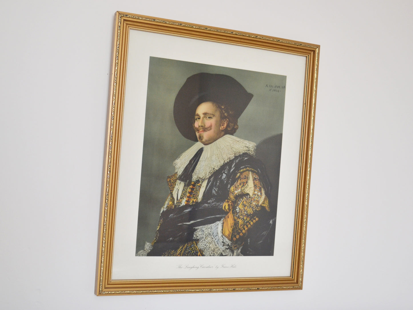 Framed chromolithograph of The Laughing Cavalier by Frans Hals, gilt wood frame, England 1932, front view.