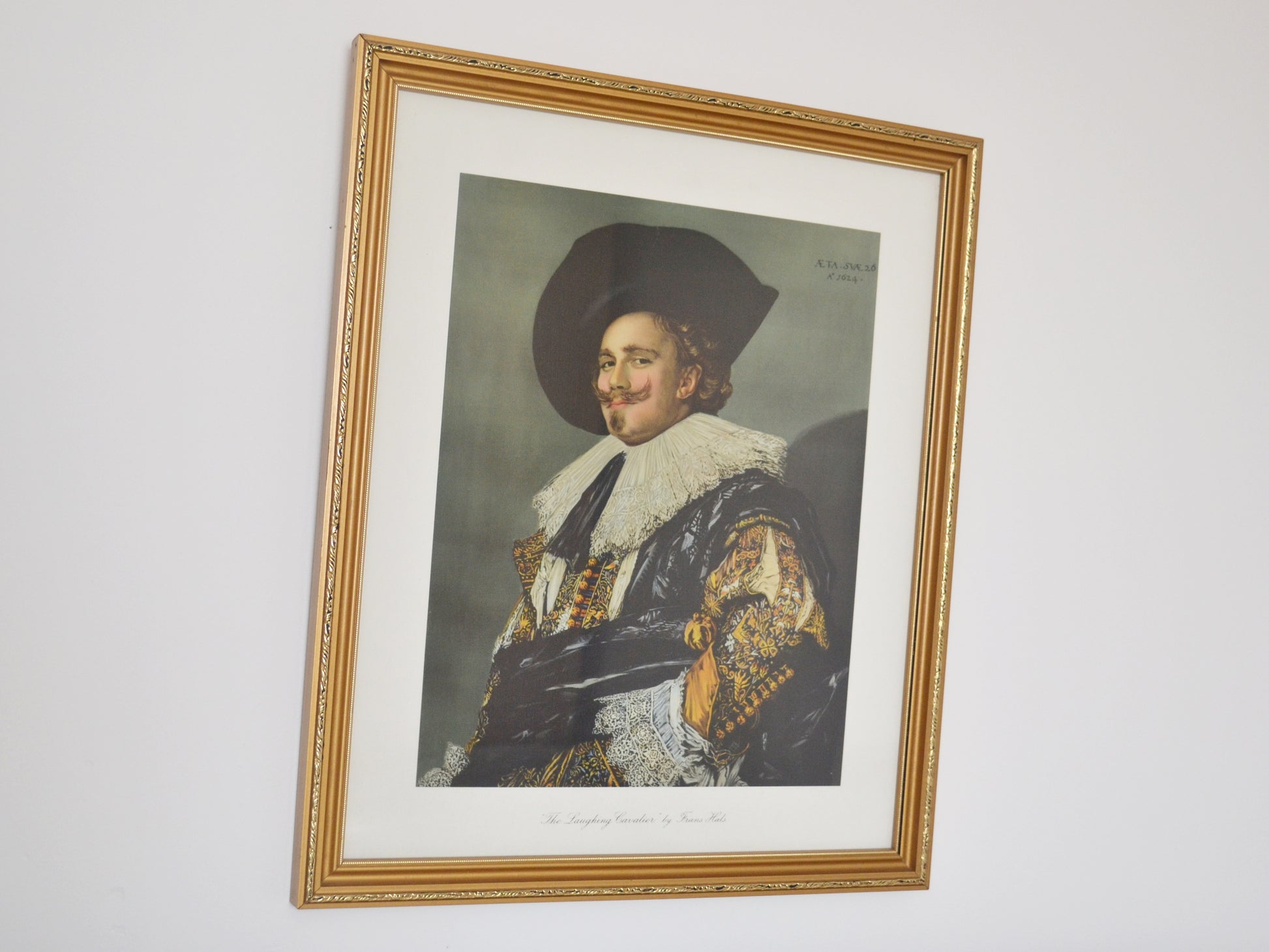 Framed chromolithograph of The Laughing Cavalier by Frans Hals, gilt wood frame, England 1932, front view.