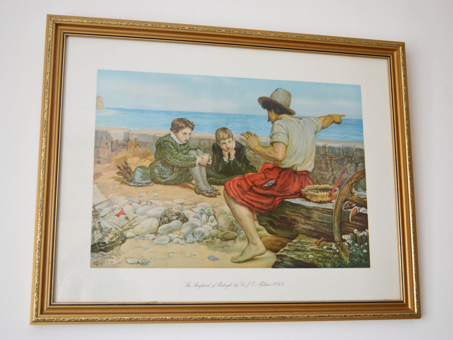 The Boyhood of Raleigh by Millais, chromolithograph detail, sailor pointing to sea, two boys listening, England 1932.