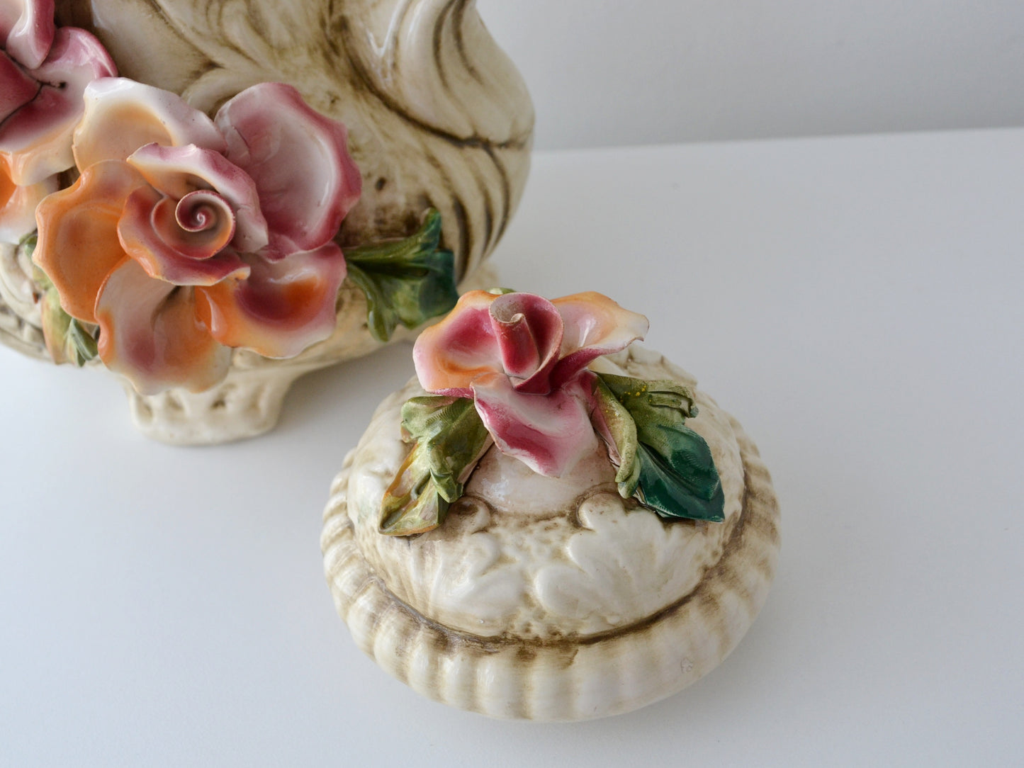 Applied flower detail on Capodimonte duck jug lid, minor chip visible, circa 1970s.