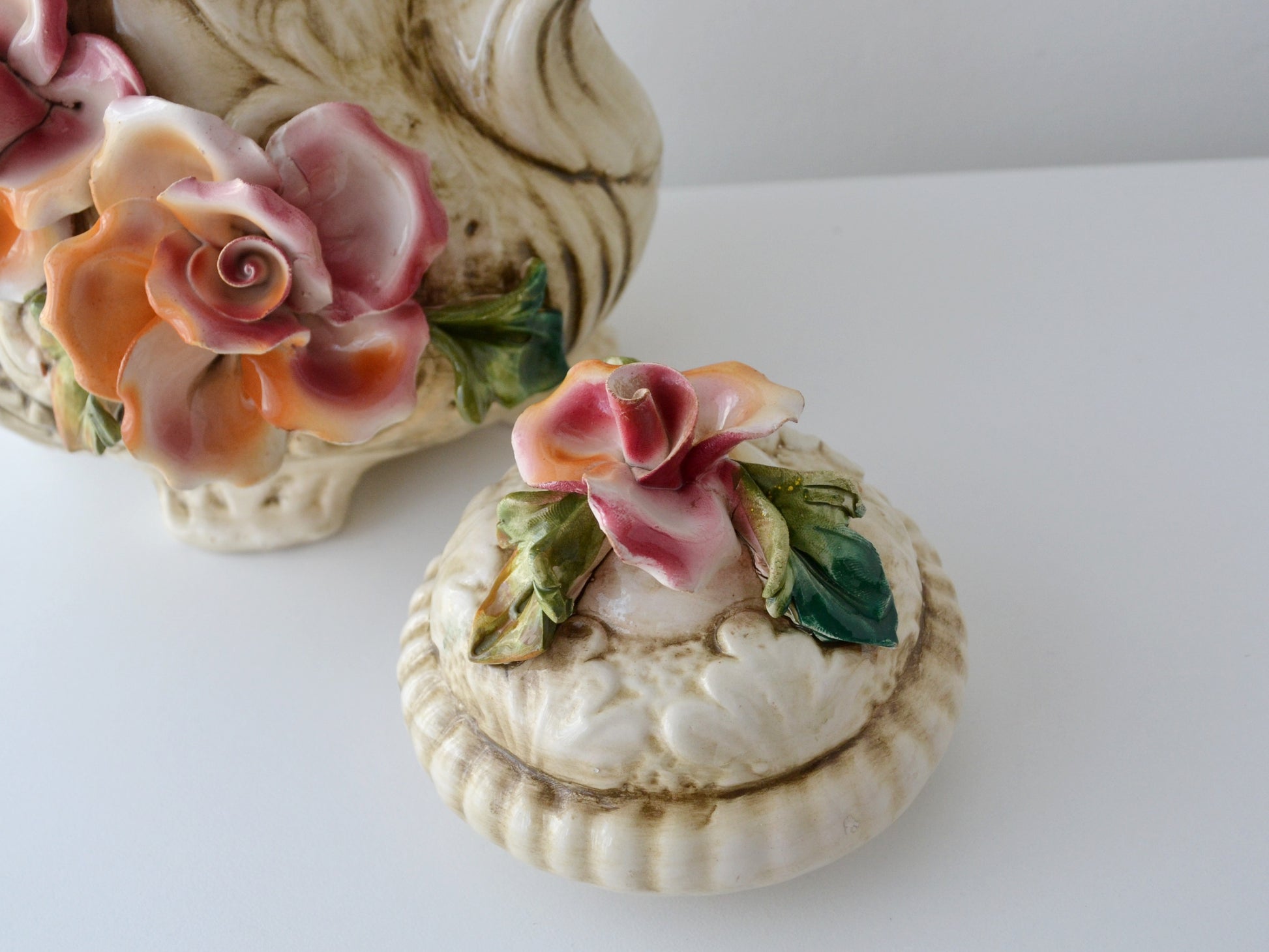 Applied flower detail on Capodimonte duck jug lid, minor chip visible, circa 1970s.