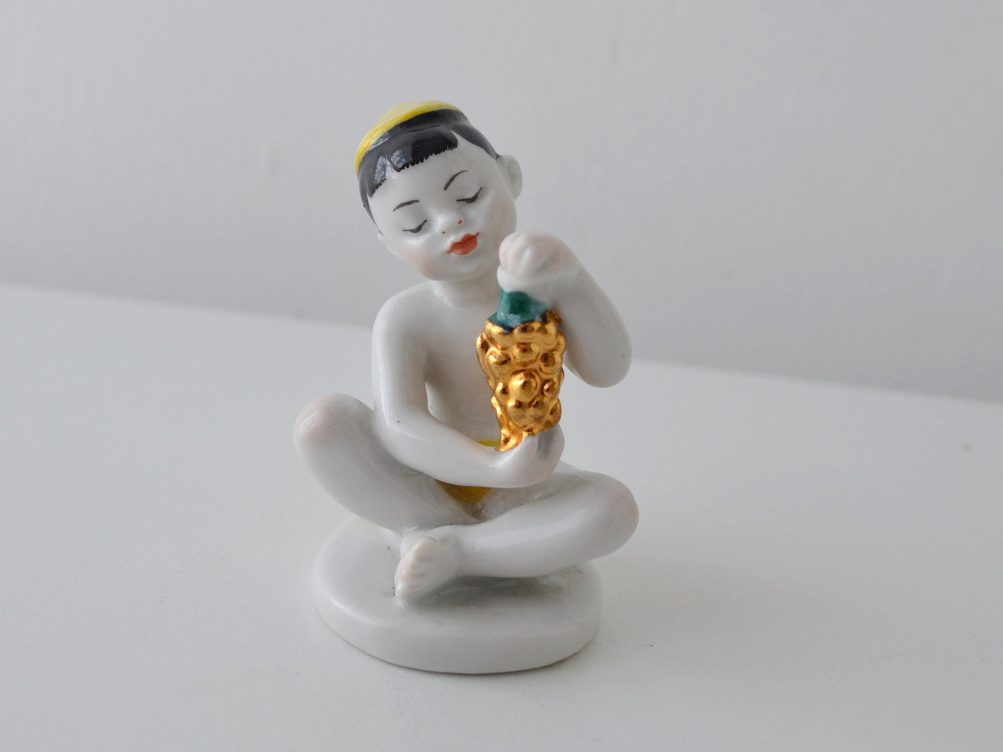 Gilt grape detail on Soviet LFZ porcelain boy figurine, circa 1960s.